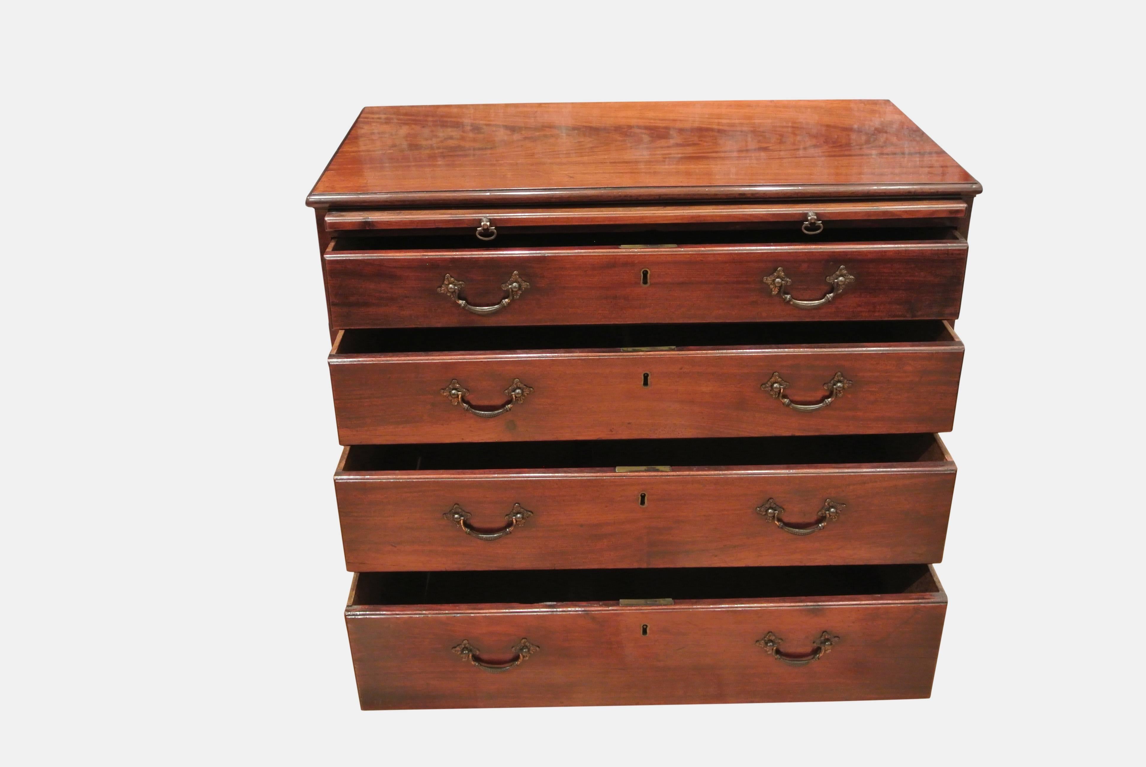 A fine quality Chippendale period mahogany chest of drawers with brushing slide and brass handles on bracket feet. In excellent original condition.
