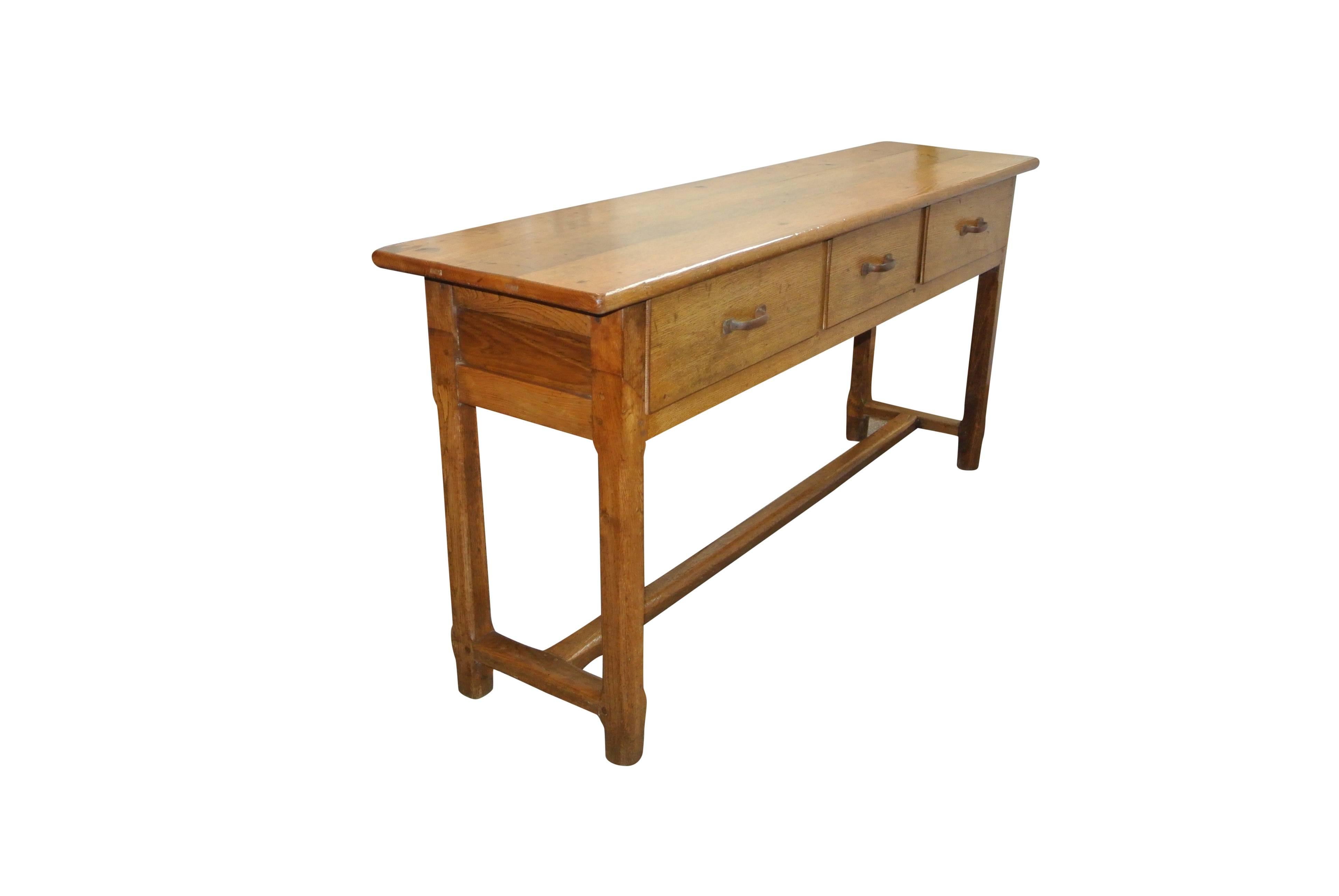Late 19th century French golden oak three-drawer server of good colour. Later iron handles.