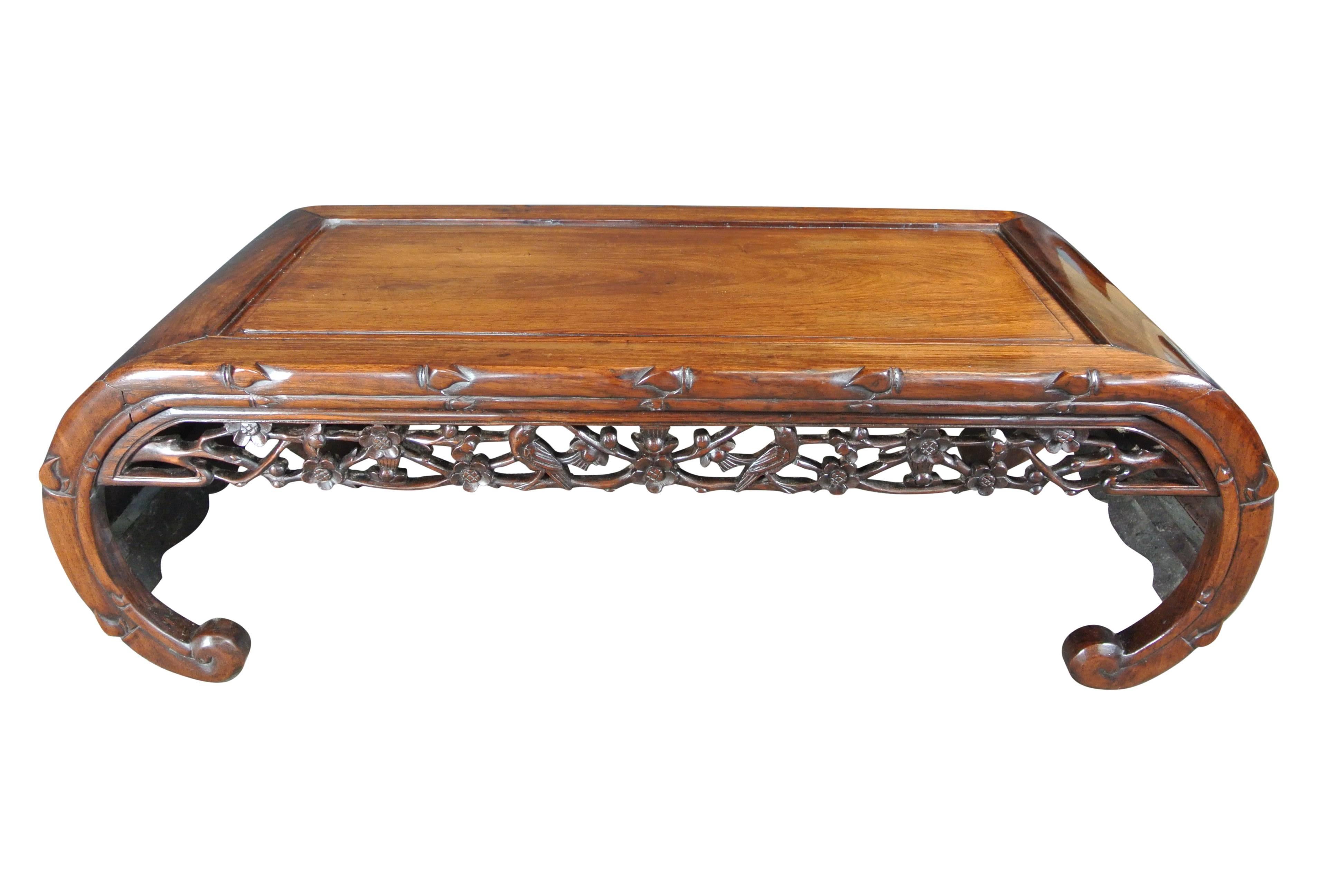 Early 20th century beautifully figured hardwood opium or coffee table with carved decoration to the sides and decorative open fretwork to the front and back.