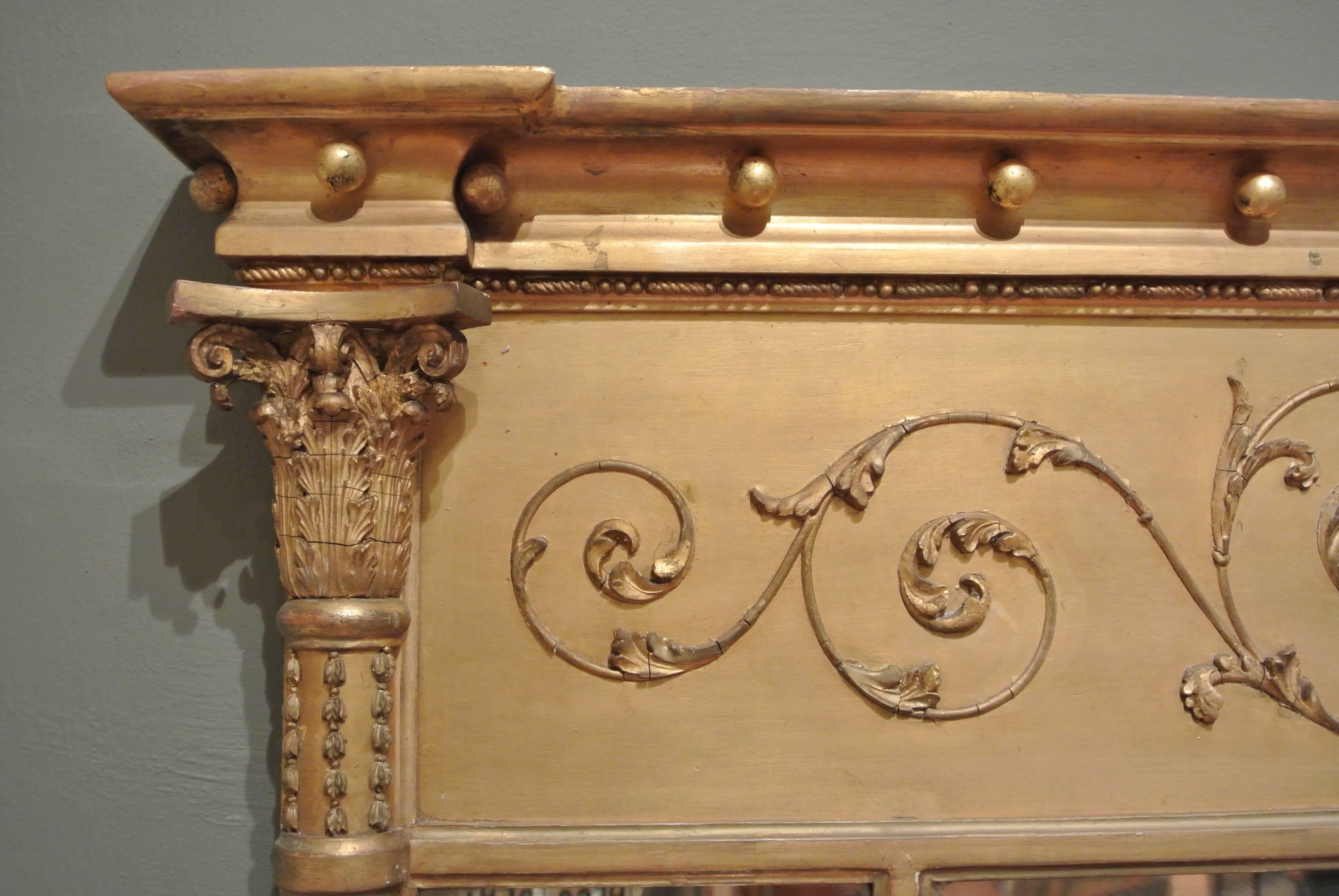 19th century Regency gilt framed triple plate overmantel mirror in the Adam style, with urn and foliate decoration.