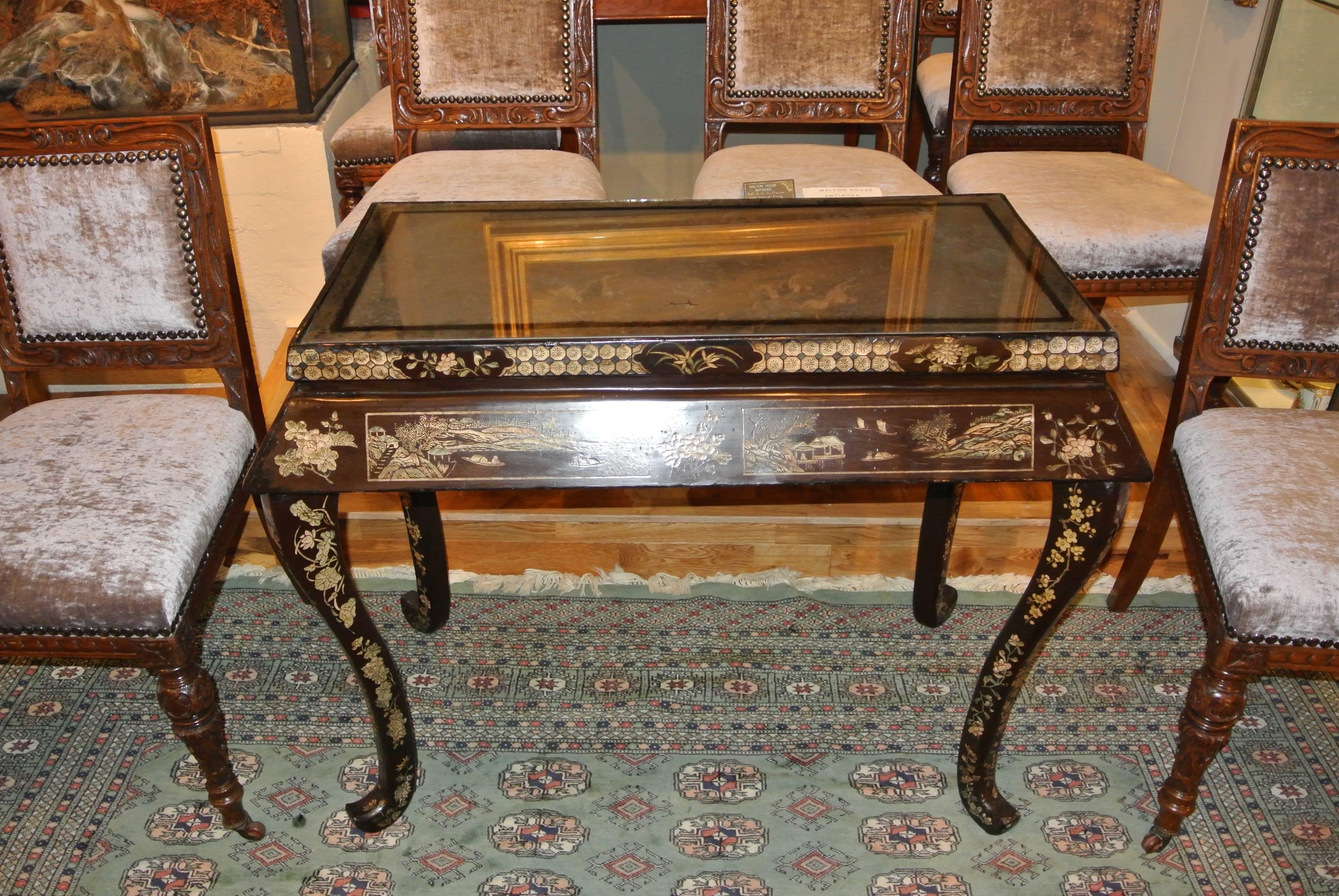 An early 19th century japanned console table with the original mirrored top.