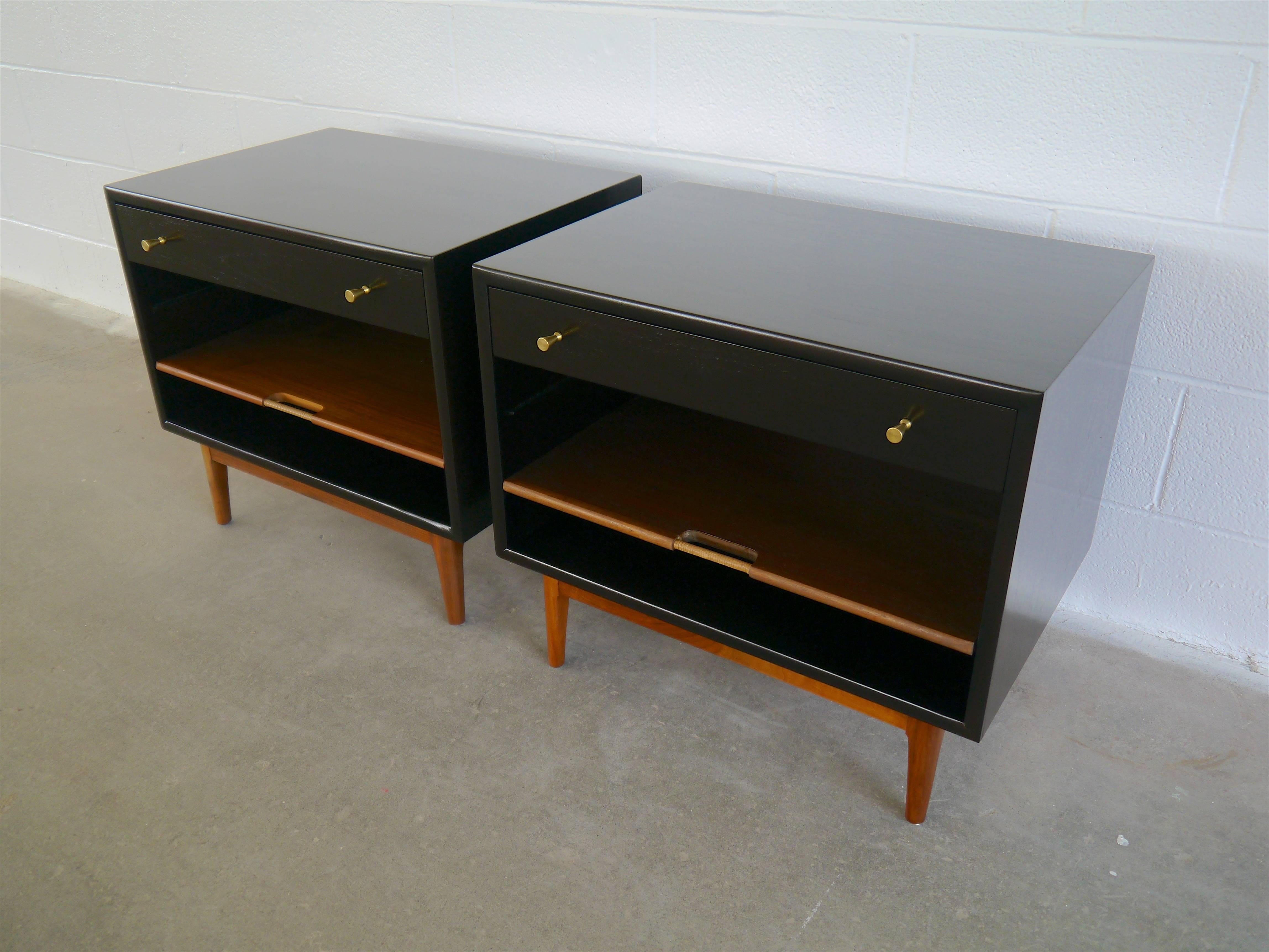 Nightstands in walnut by Kipp Stewart. These large nightstands have drawers and an adjustable sliding shelf with raffia handles. The pulls are solid machined brass. We borrowed the finish from Dunbar pieces of the period, the cases done in dark