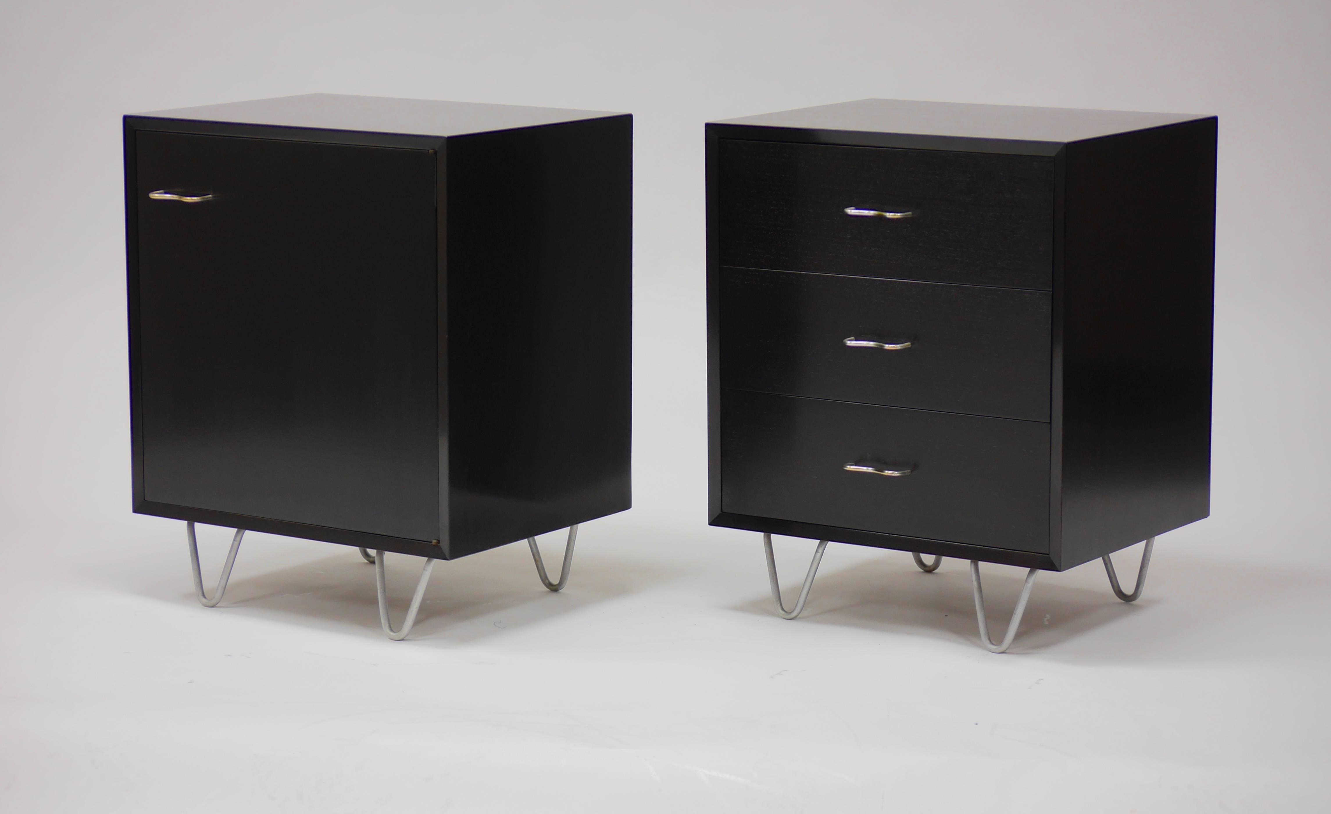 Pair of nightstands in dark walnut by George Nelson for Herman Miller. One having a single compartment with an adjustable shelf, the other three drawers. Both on hairpin legs.