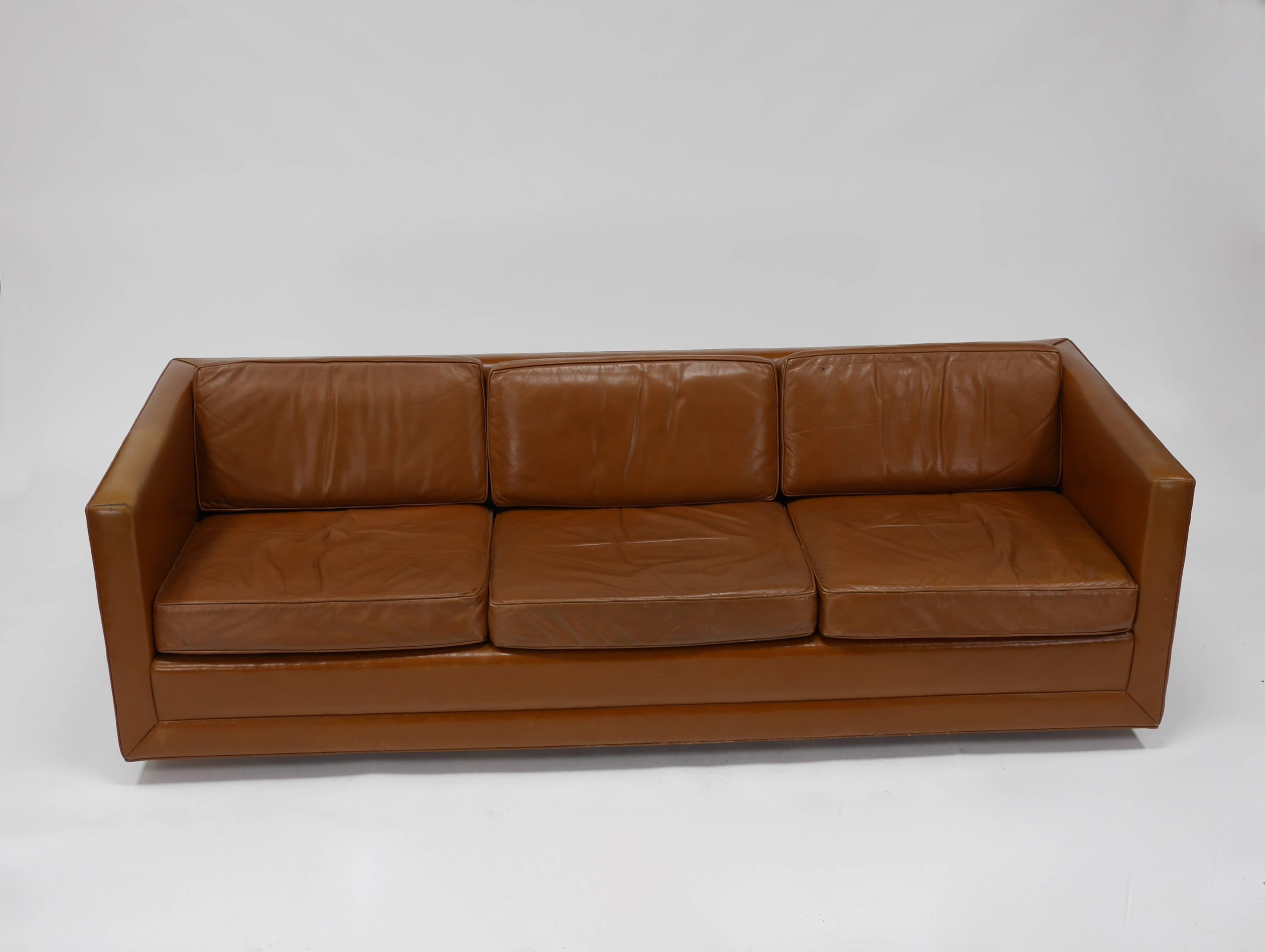 Leather tuxedo sofa by Harvey Probber. Original saddle leather upholstery. Walnut dowel legs. Patina  similar to that of a Classic leather club chair. Call or email for detailed condition report. Labeled Harvey Probber.