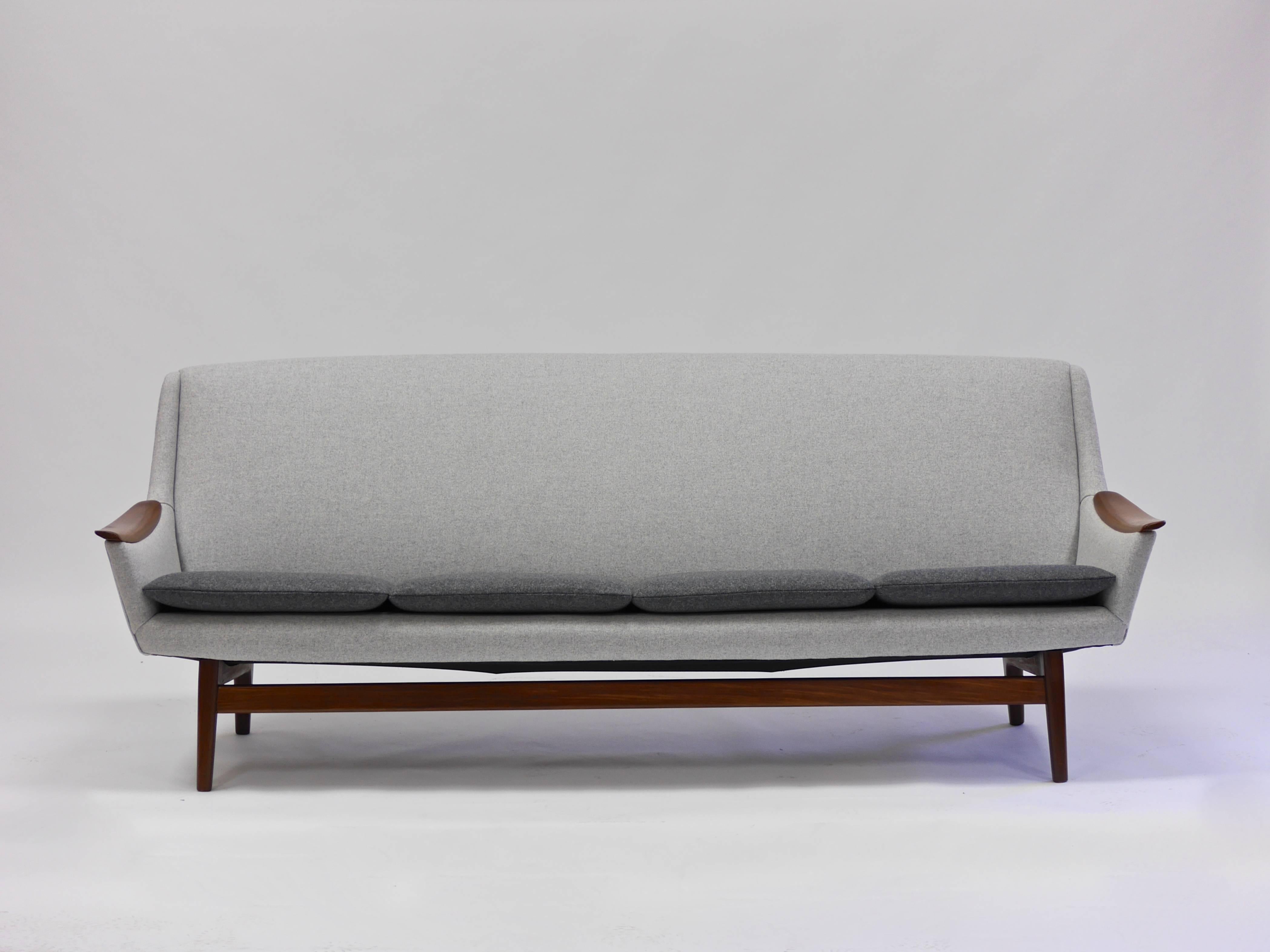 An exceptional example of modern Scandinavian design with its expressive form and fine detailing. Designed in Norway by Rastad & Relling in the 1960s. Masterfully reupholstered in two-tone Kvadrat Divina Melange. Beautiful to look at, well made and