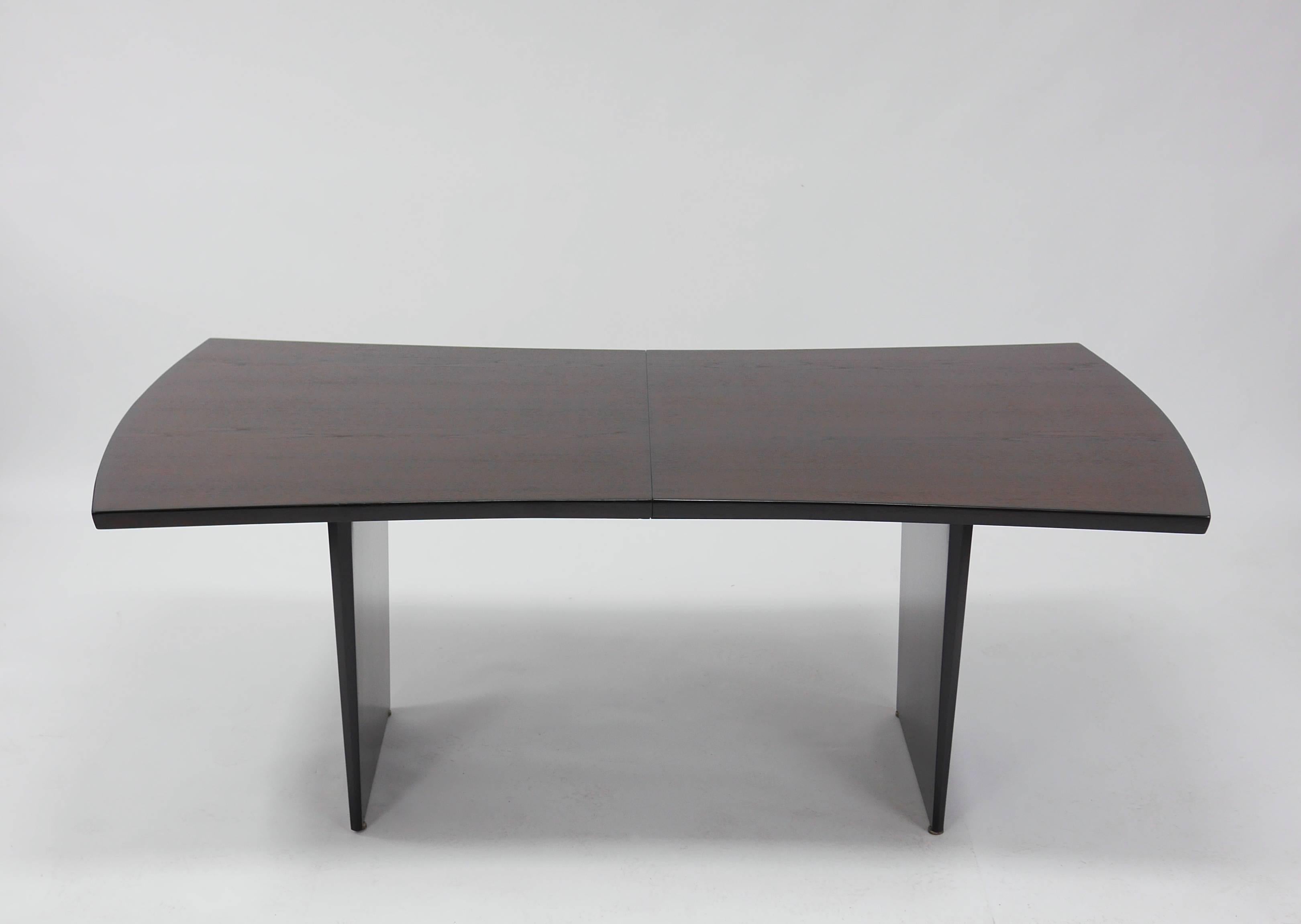 Bow tie dining table by Harvey Probber. Elegant, well made and very solid.
Walnut top with beveled edge banding, on 2 slab legs. Two tone lacquer top, the edge banding deep brown, the top Walnut.