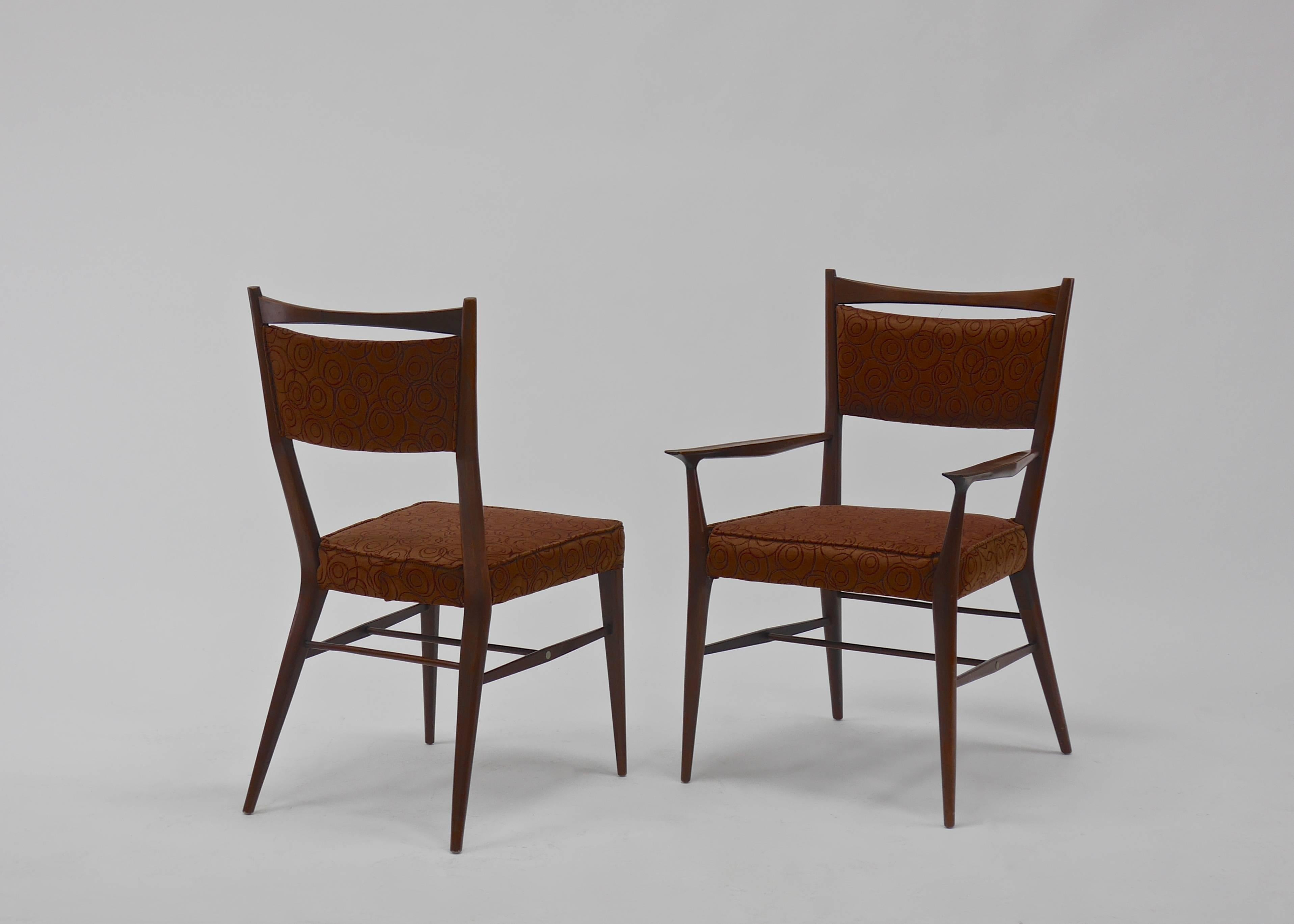Eight Irwin collection dining chairs by Paul McCobb. Upholstered seats and backs. Good vintage condition. Walnut frames in an oiled finish.