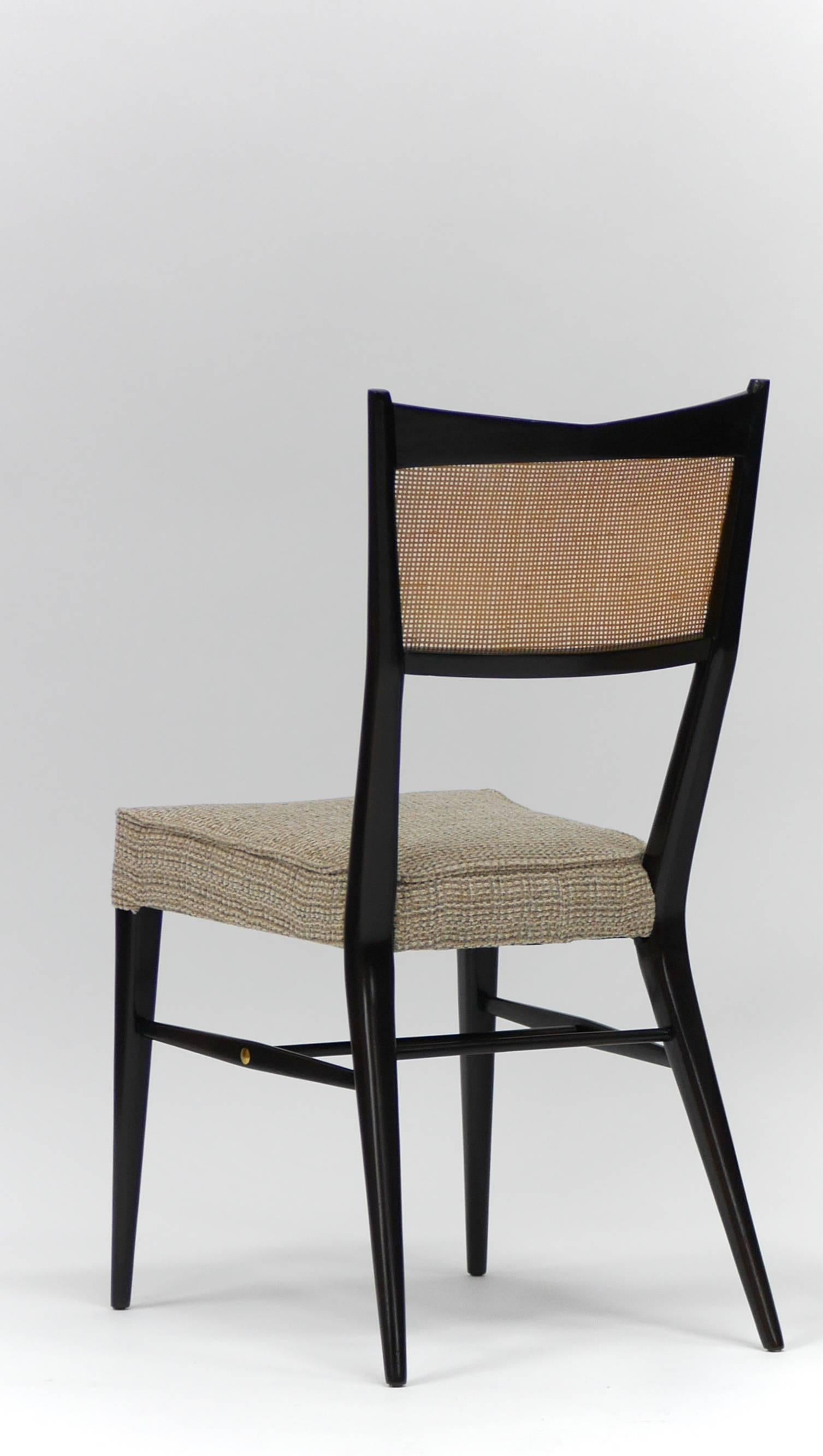 Set of eight Paul McCobb Irwin collection dining chairs with sculpted mahogany frames and caned backs. Six side chairs, two armchairs. Refinished and re caned. Upholstery shown is for reference only, chairs are stripped and are ready for client's
