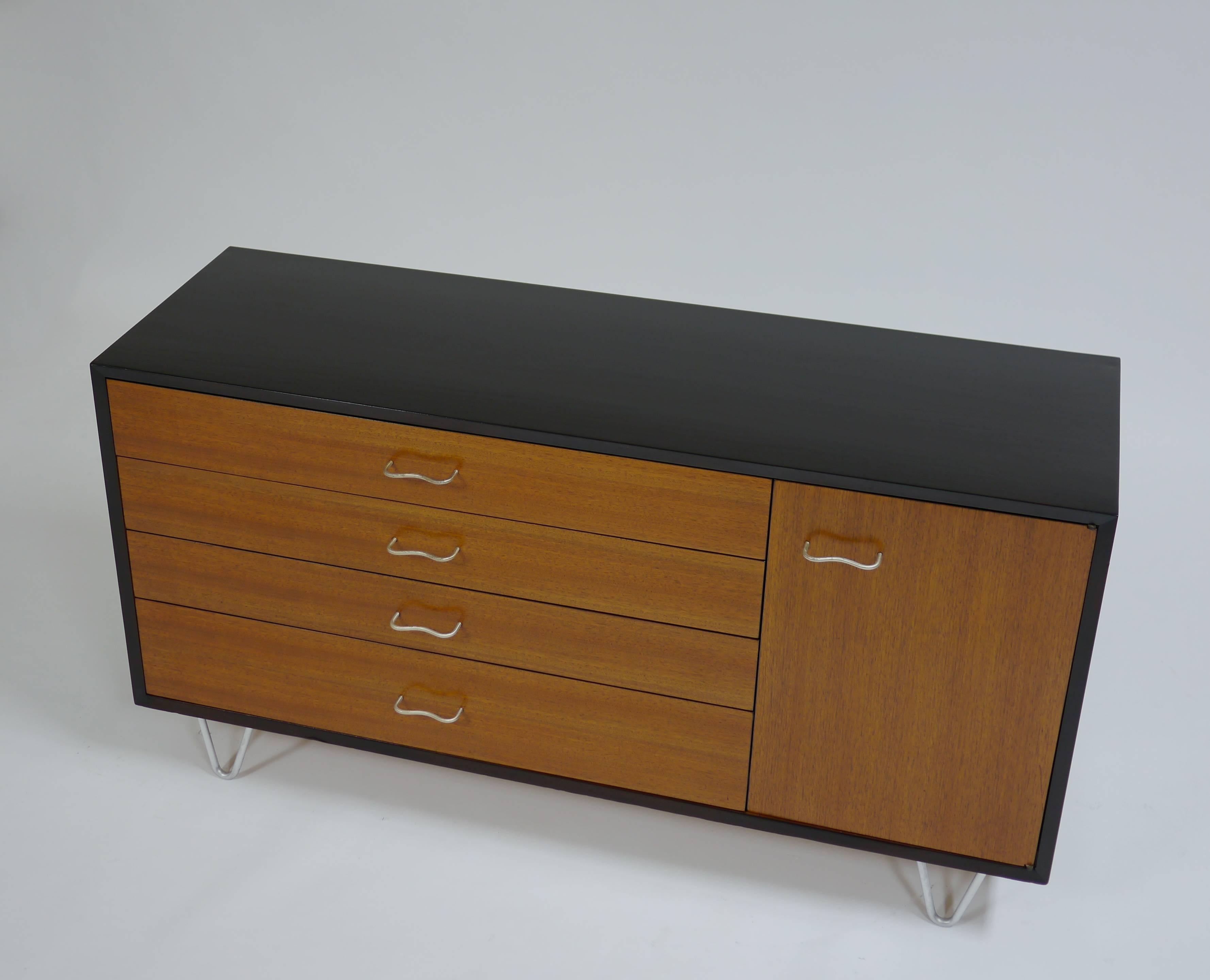 Dresser on hairpin legs by George Nelson for Herman Miller. Having four drawers, one cabinet with an adjustable shelf.