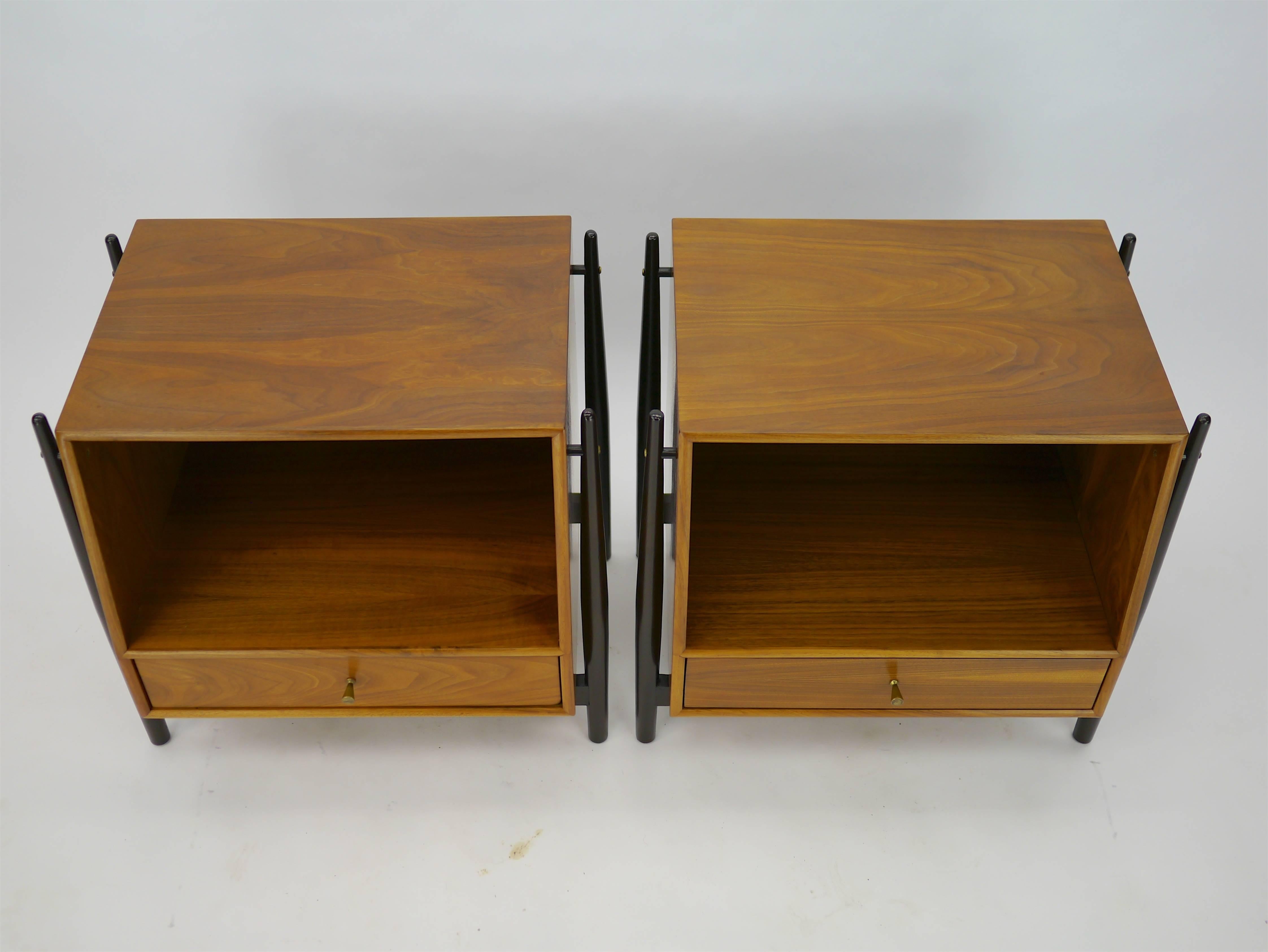 Nightstands in walnut by Kipp Stewart for Drexel. These nightstands have an exposed frame with a floating case piece. We borrowed the finish from Dunbar pieces of the period, the frames done in dark walnut, the cases left natural.