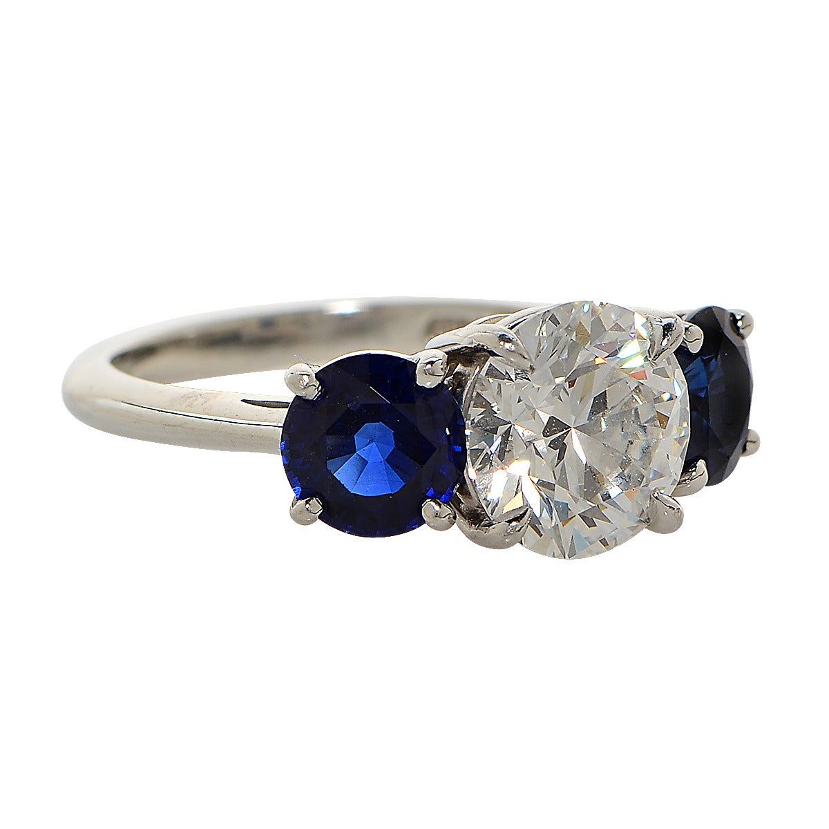 Tiffany & Co. Platinum Ring with a 2.35ct E/VS1 Round Brilliant Cut Diamond, also Accompanied by a GIA Certificate, Flanked by two Royal Blue Sapphires Weighing 2.22ct Total.