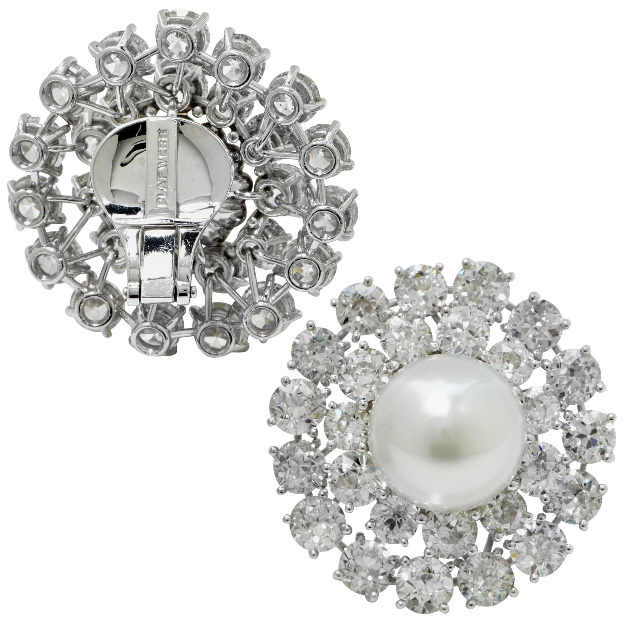 David Webb platinum clip earrings featuring 2 matching pearls surrounded by 52 transitional cut diamonds weighing approximately 20cts.

These earrings measure 1.22 inch in height by 1.18 inch in width by .60 inch in depth (not including clip)
It is