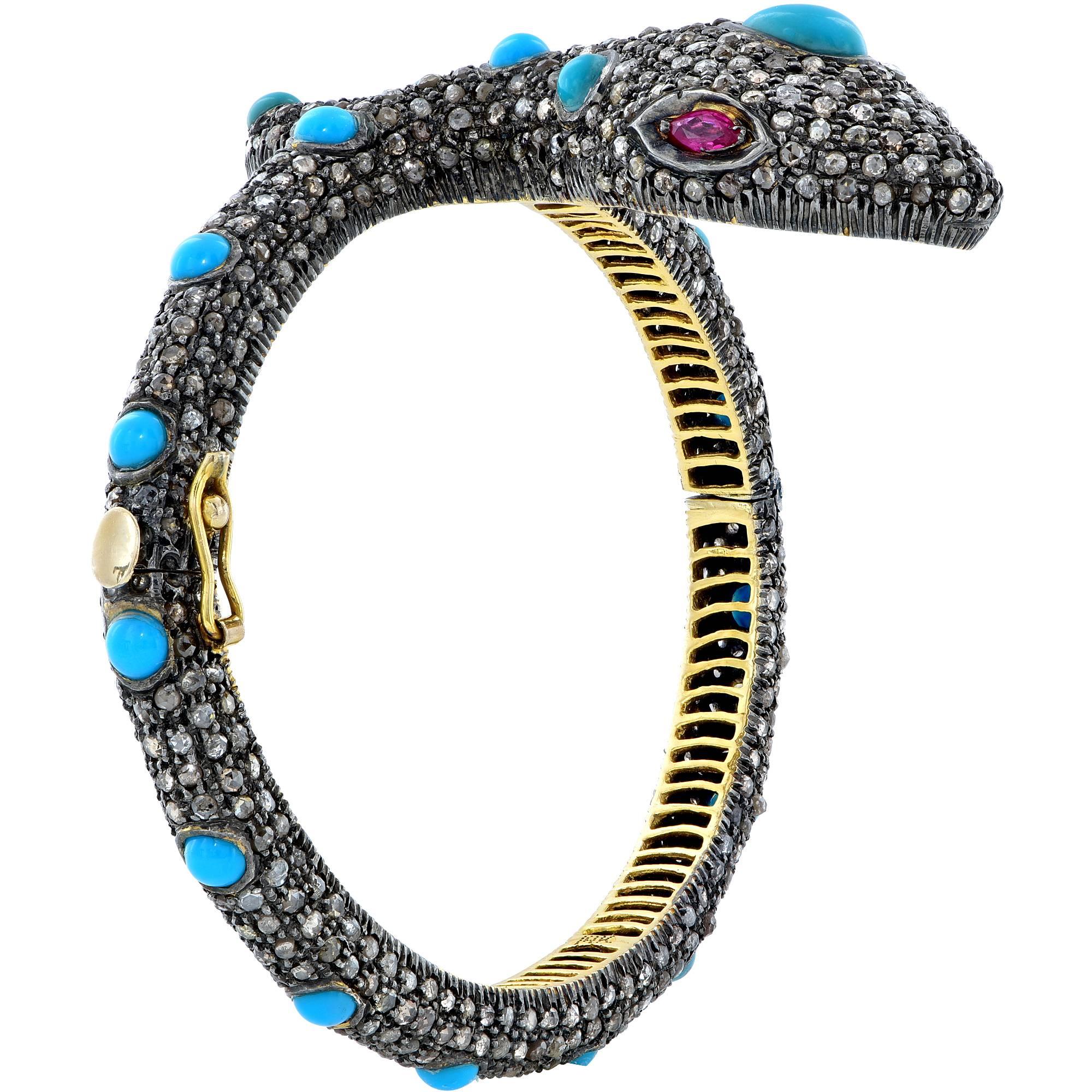 14k yellow gold and silver cobra snake bangle featuring cabochon round and pear shape turquoise surrounded by mixed cut diamond and red gemstone eyes.

It is stamped and/or tested as 14k gold.
This bangle weighs 41.5 grams.

This diamond and