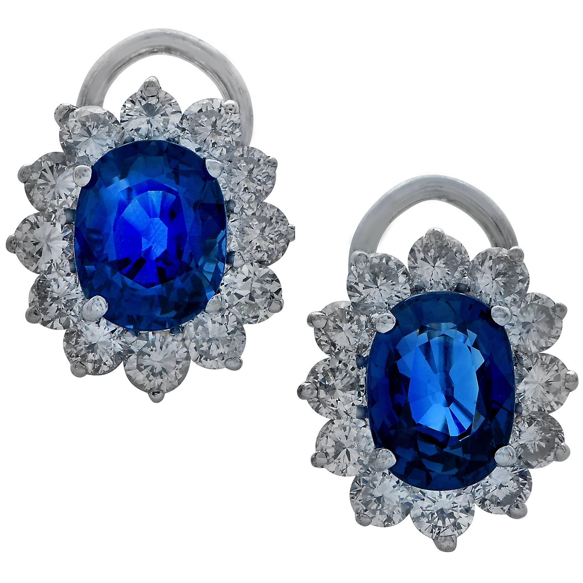 18k white gold earring featuring two oval sapphires weighing approximately 5cts surrounded 24 round brilliant cut diamonds weighing approximately 2.40cts F-G color and VS-SI clarity.

These earrings measure .60 inch in height by .50 inch in