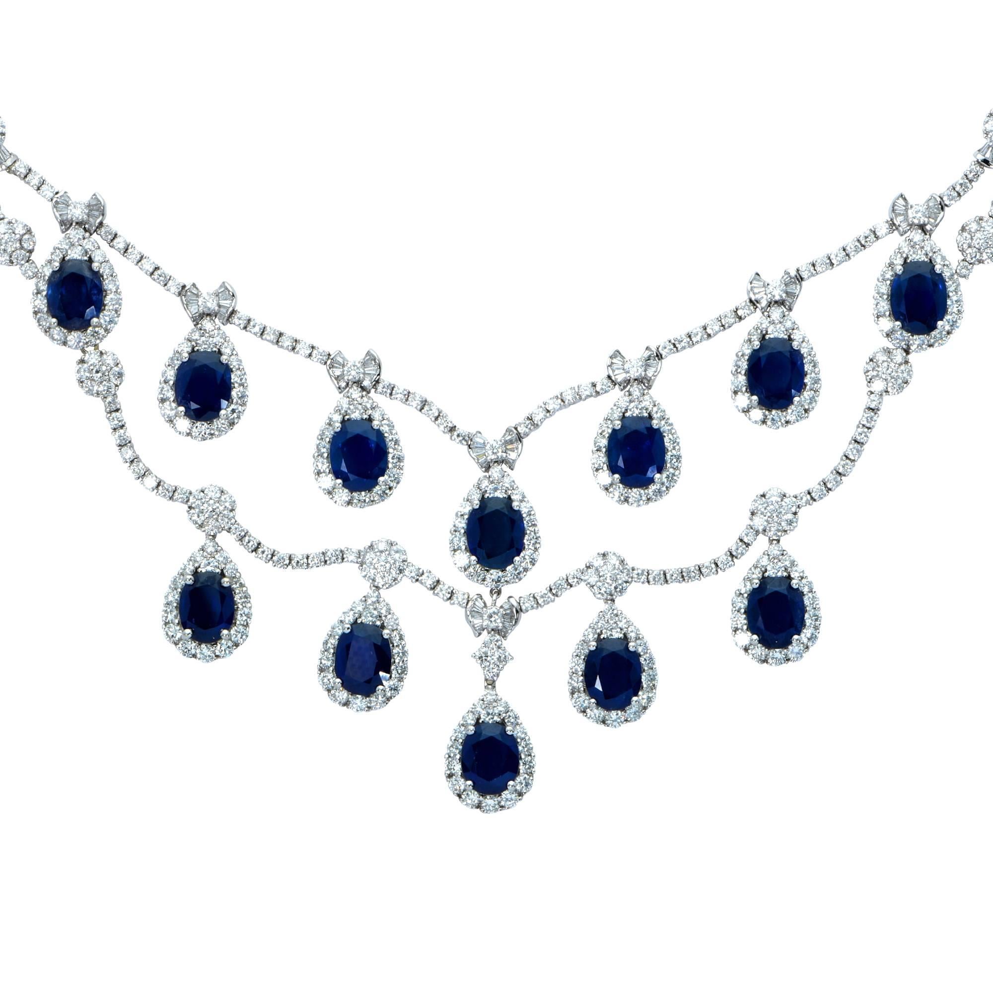 Elegant sapphire and diamond necklace crafted in 18k white gold. This necklace boasts a total approximate weight of 40 carats of rich deep royal blue oval shape sapphires set in a sea of 539 white round brilliant and baguette cut diamonds weighing