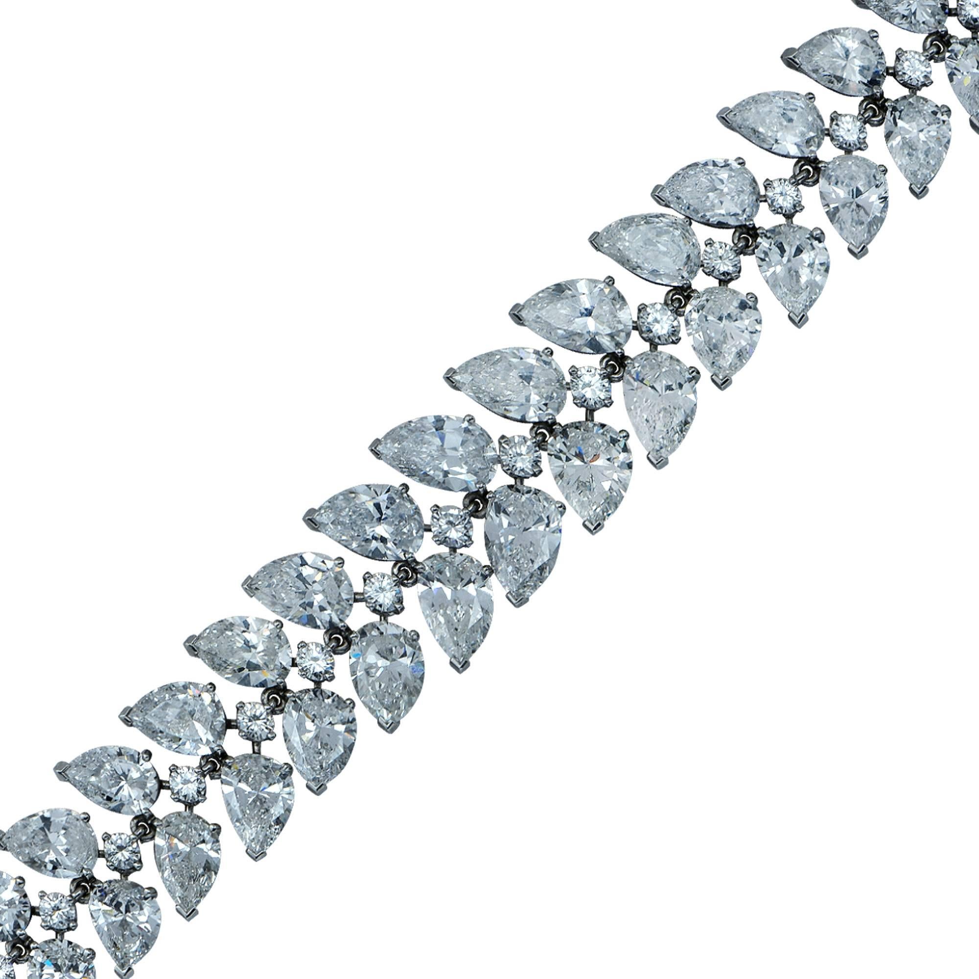 Important platinum handmade bracelet featuring 46 gorgeous pear shape diamonds graduating from approximately 1.40cts in the center down to .50cts on the ends, accented by 23 round brilliant cut diamonds. This spectacular bracelet contains