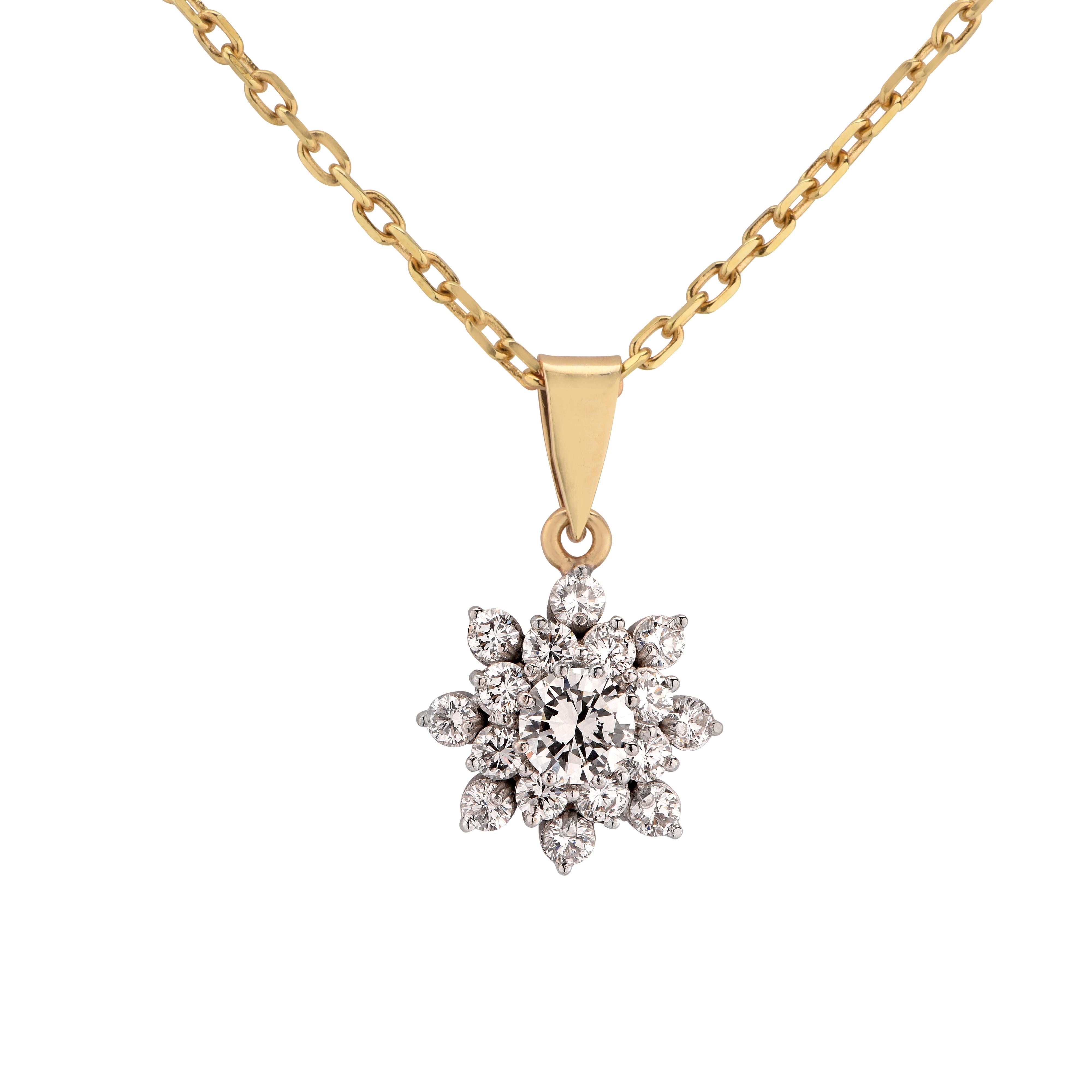 Stunning necklace and pendant crafted in 18 Karat Yellow and White gold, showcasing a .40 carat round brilliant cut diamond F color and VS clarity, accented by 16 round brilliant cut diamonds weighing approximately .60 carats, set in a snow-flake