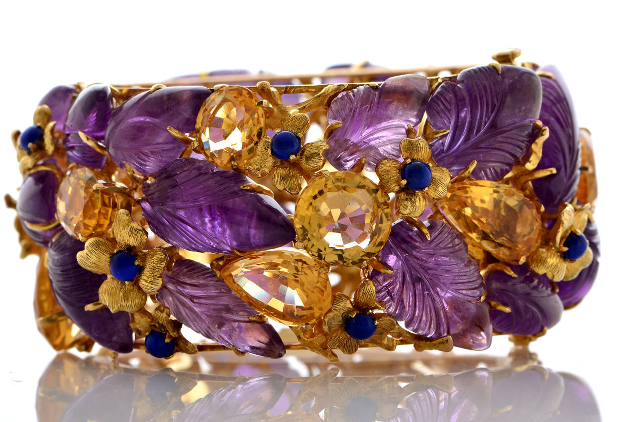 18K Yellow Gold Bangle Bracelet with Amethyst Leaves, Yellow Citrine and Gold Flowers Motifs set with Lapis. This is a Mario Buccellati Production which includes 13 Carved Amethyst ~80cts, 7 Carved Amethyst ~30cts, 13 Yellow Citrines ~30cts and 13