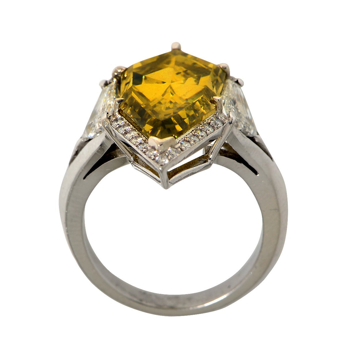 This gorgeous platinum ring features a GIA graded natural fancy deep brownish greenish yellow kite shaped diamond weighing 7.94ct accented by 1.20cts of round brilliant cut and kite cut diamonds, G color, VS clarity. Total diamond weight is