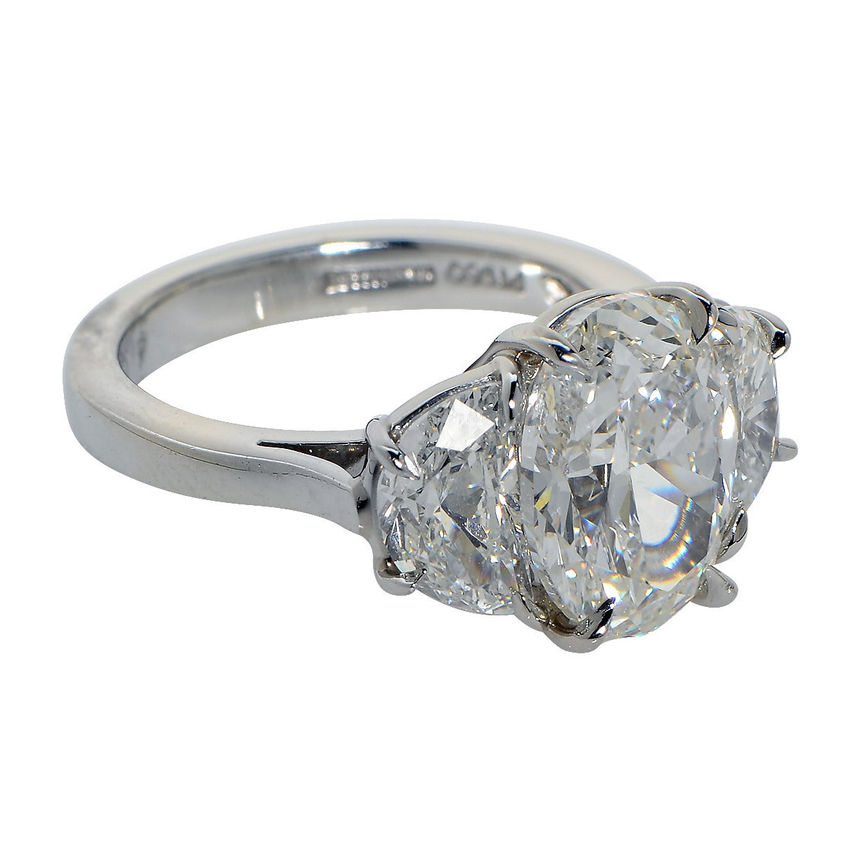 Platinum Custom-Made Ring Containing a 4.03ct Oval Cut Diamond H Color and SI1 Clarity GIA, Flanked by 2 Half Moon Cut Diamonds weighing 1.69ct H Color and VS2 Clarity. Total Diamond Weight is 5.72cts. Ring Size: 6.