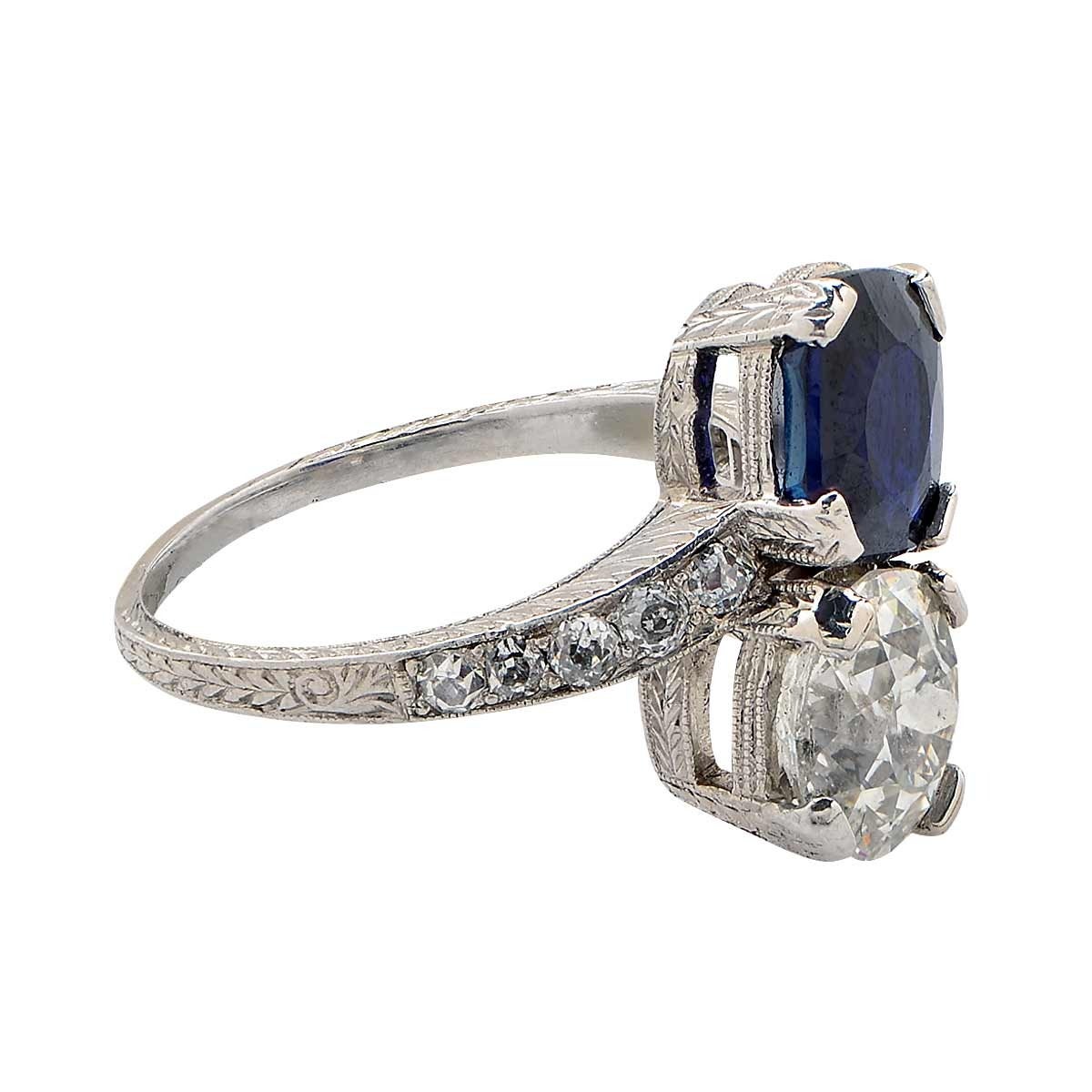 This precious platinum Art Deco bypass ring features a 1.81ct old miner cut diamond H color SI clarity and a 2.06ct AGL no heat sapphire.

The ring size is currently 5.75 but can be sized up or down.
It is stamped and/or tested as platinum.
The