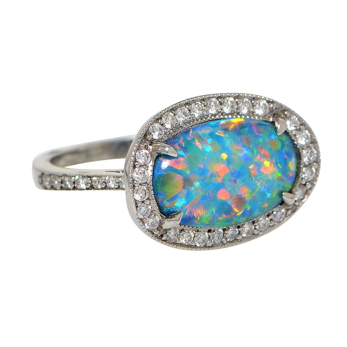 Unique vintage ring crafted in platinum, featuring a stunning vivid and fiery 2.77 carat oval cut Natural Black Opal, set east-west and adorned with approximately 1 carat of round brilliant cut diamonds. This ring is a size 6.

Our pieces are all
