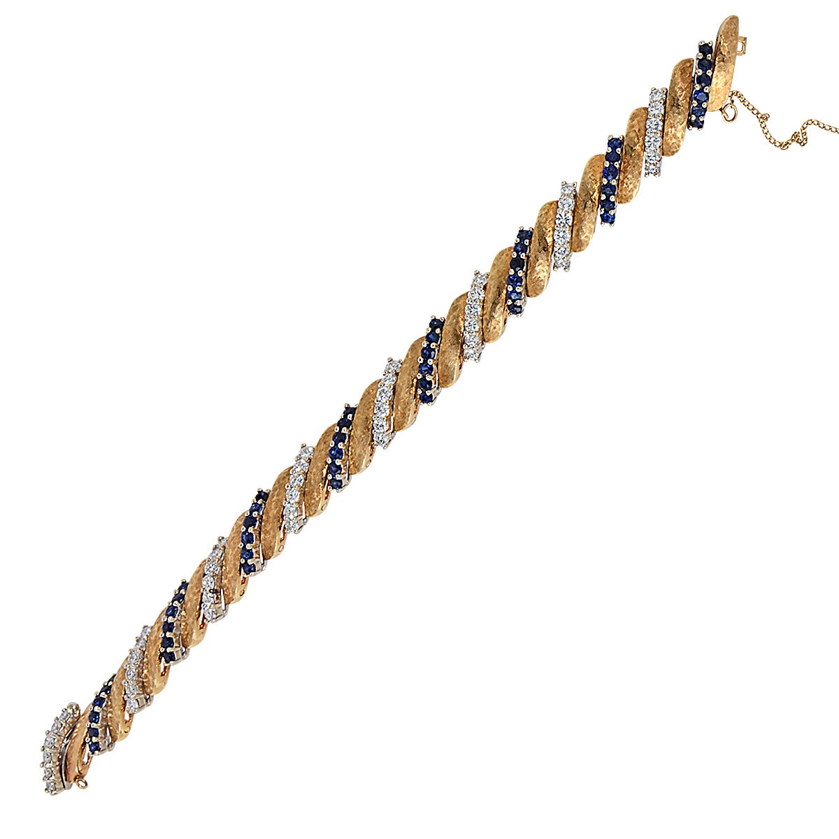 18k yellow gold bracelet featuring 48 round brilliant cut diamonds weighing approximately 4cts, F color and VS clarity and 48 round blue sapphires weighing approximately 5cts.

Measurements available upon request.
It is stamped and/or tested as 18k