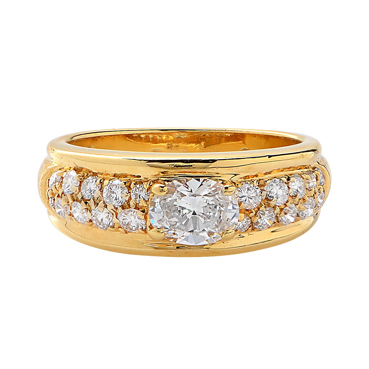 18k yellow gold ring featuring a .55ct oval diamond F color and VS1 clarity, surrounded by 20 round brilliant cut diamonds approximately .50cts F color and VS clarity.

The ring is currently a size 6.25 and cannot be sized.
It is stamped and/or