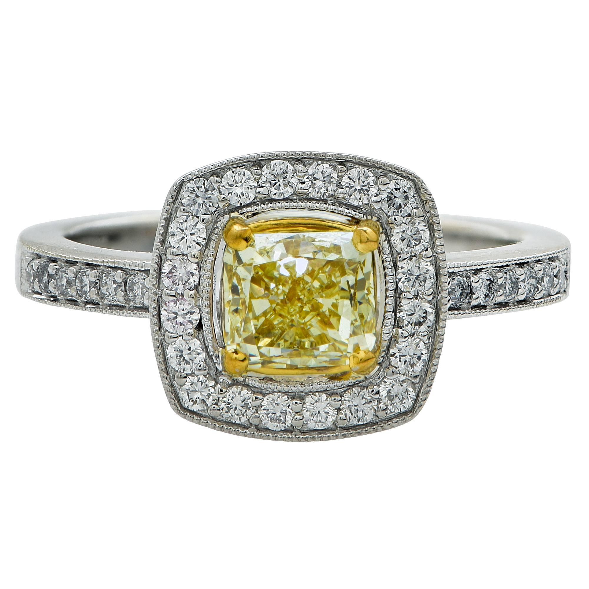 18k white and yellow gold ring featuring a GIA graded light yellow cushion cut diamond weighing 1.01cts and VVS2 clarity which is accented by .31cts of round brilliant cut diamonds G color, VS clarity.