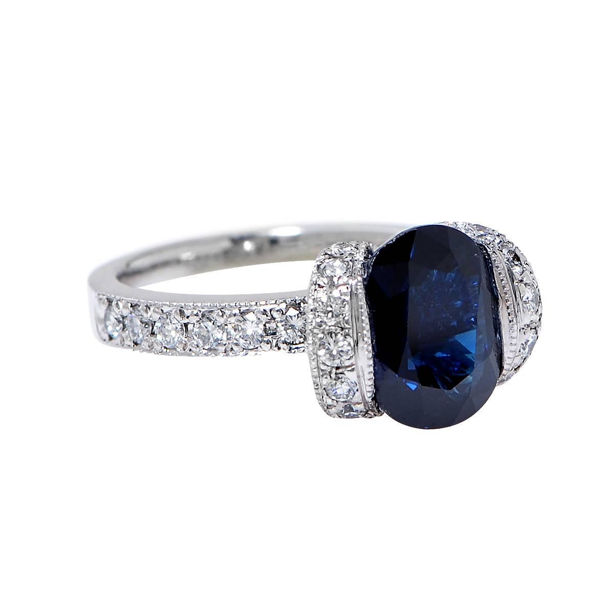 Spectacular Vivid Diamonds ring crafted in Platinum, showcasing a GIA Certified dark blue oval cut Sapphire weighing 2.71 carats accented by brilliant cut diamonds weighing approximately .45 carats total, G Color, VS Clarity.

Our pieces are all