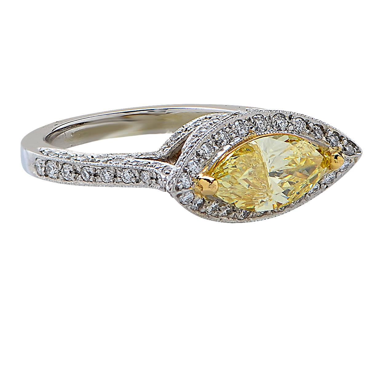 1.22 Carat GIA Graded Fancy Yellow Marquise Cut Diamond Set in a Platinum Ring Accented by 110 Round Brilliant Cut Diamonds Weighing Approximately .65 Carats, F Color, VS Clarity. Total Diamond Weight 1.87 Carats.