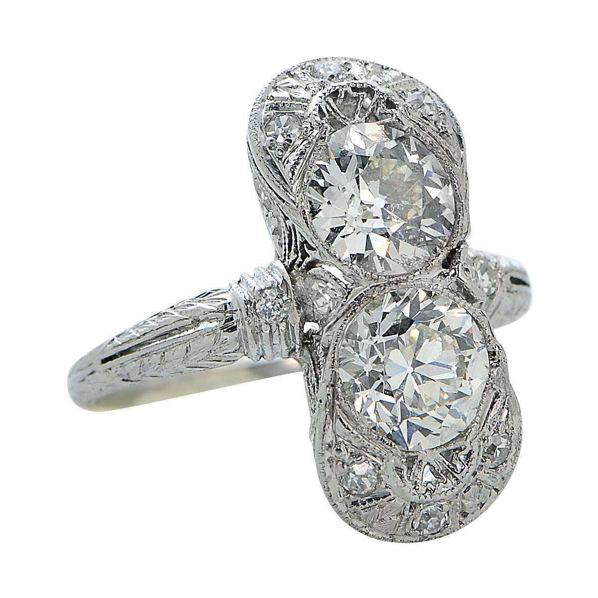 Spectacular Art Deco ring crafted in platinum, showcasing 2 Old European Cut Diamonds Weighing approximately 2.00 carats total, detailed with milgrain and filigree. This beautiful ring is a size 5.5 and weighs 5.28 grams.  

Our pieces are all
