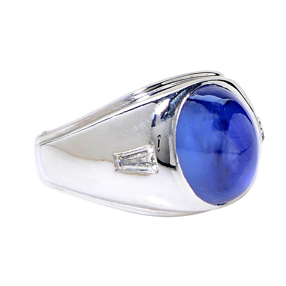 14 Karat White Gold Ring Set with an Unheated Star Sapphire Weighing Approximately 14.00 Carats & 2 Tapered Baguettes Weighing Approximately .50 Carats.

Ring Size: 8.25
Weight: 20.21 grams

This Star Sapphire Ring is Accompanied by a Retail