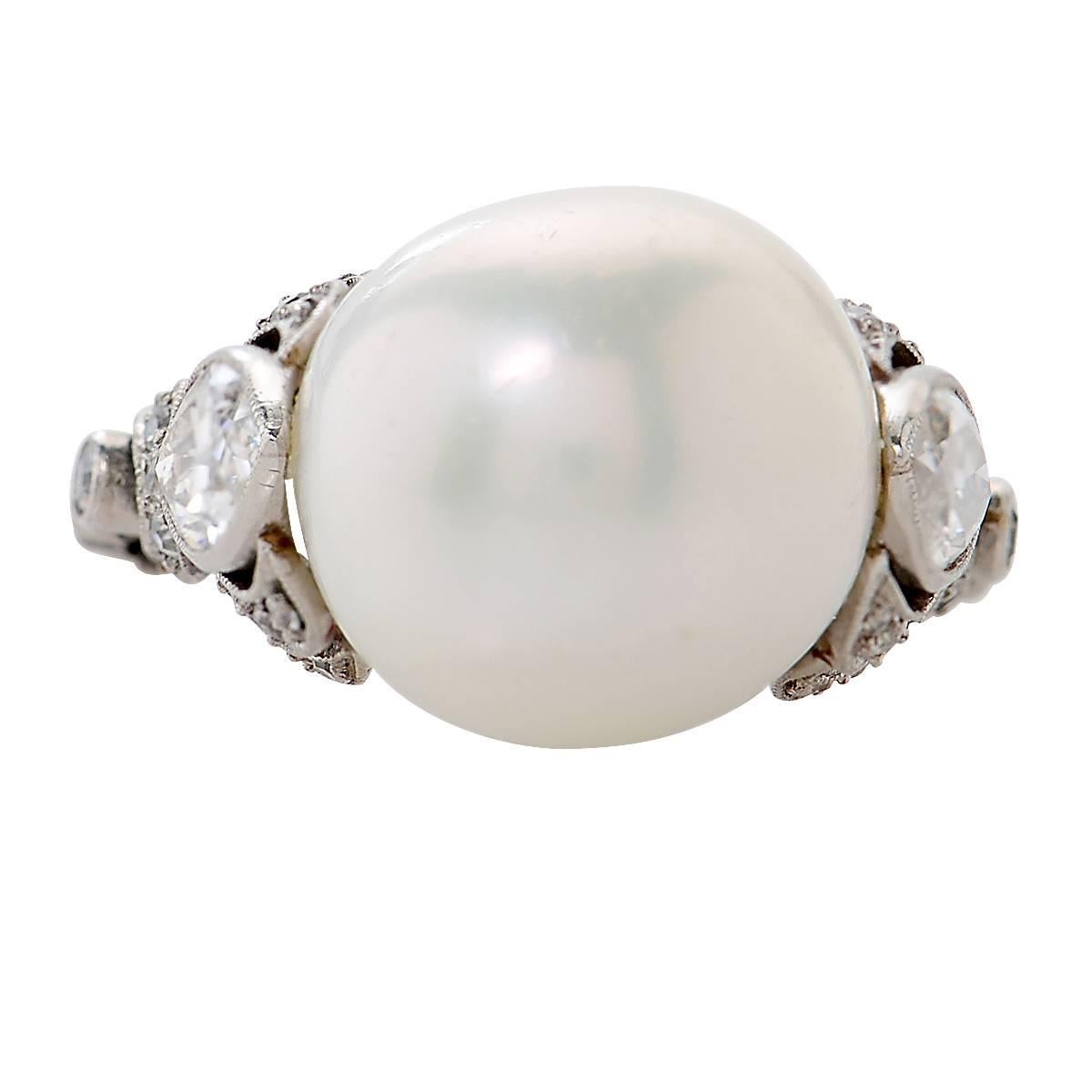 Platinum Art Deco Ring Containing a GIA Graded 11.88mm Freshwater Natural Pearl Flanked by 2 Navette Shape Diamonds Weighing Approximately .70 Carats and Accented by 37 Old European Cut Diamonds Weighing Approximately .30 Carats. Ring Size is 6.5.