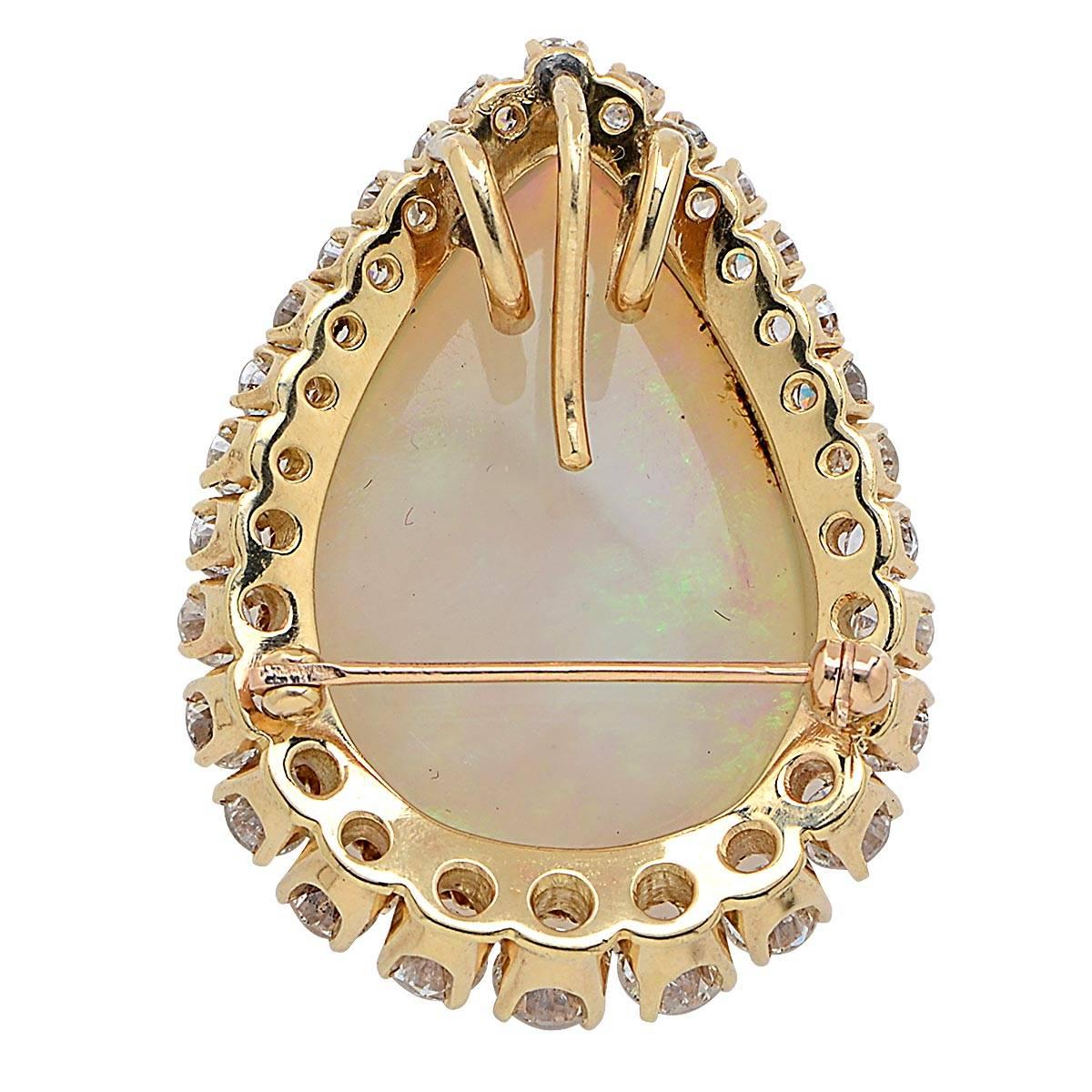 14 Karat Yellow Gold Vintage Brooch/Pendant Featuring a Cabochon Opal Accented by 4 Carats of Round Brilliant Cut Diamonds, G Color, VS Clarity. The Pin Measures 1.50