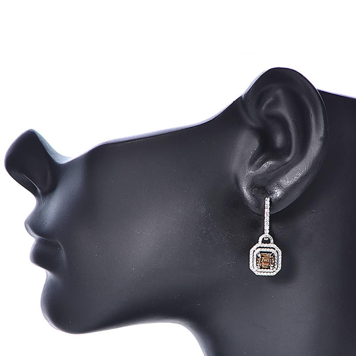 18 Karat White Gold Earrings Set with 2 Fancy Intense Brown Emerald Cut Diamonds with an Approximate Total Weight of 2.08b Carats with 146 Round Brilliant Cut Diamonds with an Approximate Total Weight of .92 Carats, G Color, VS Clarity. Total