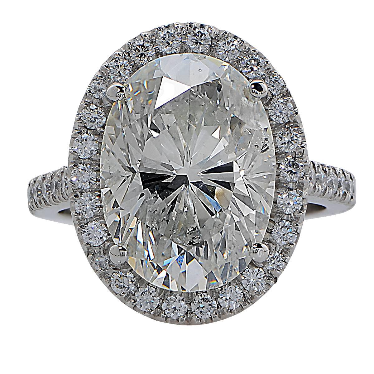 Platinum Ring Containing a 7.52 Carat, I Color, SI2 Clarity, Oval Diamond Surrounded by 48 Round Brilliant Cut Diamonds Weighing .67 Carats, G-H Color, VS Clarity.