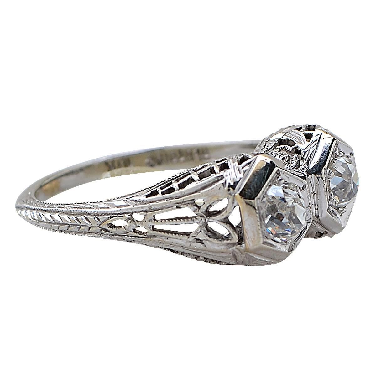 Beautiful Antique Diamond ring crafted in 18 carat white gold, showcasing 2 round brilliant cut diamonds weighing approximately .66 carats total, G color, SI clarity. This delightful ring is a size 5.25, and weighs 3.42 grams.

Our pieces are all