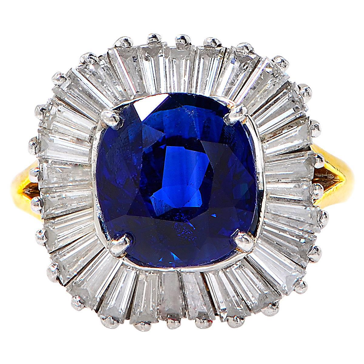 This Gorgeous Cushion Cut Sapphire Weighing 3.43 Carats Surrounded by 28 Tapered Baguettes Weighing Approximately 1.50 Carats, F-G Color, VS Clarity, Set in to an 18 Karat Yellow and White Gold Ring.

Ring Size: 5
Weight: 6.76

This Beautiful
