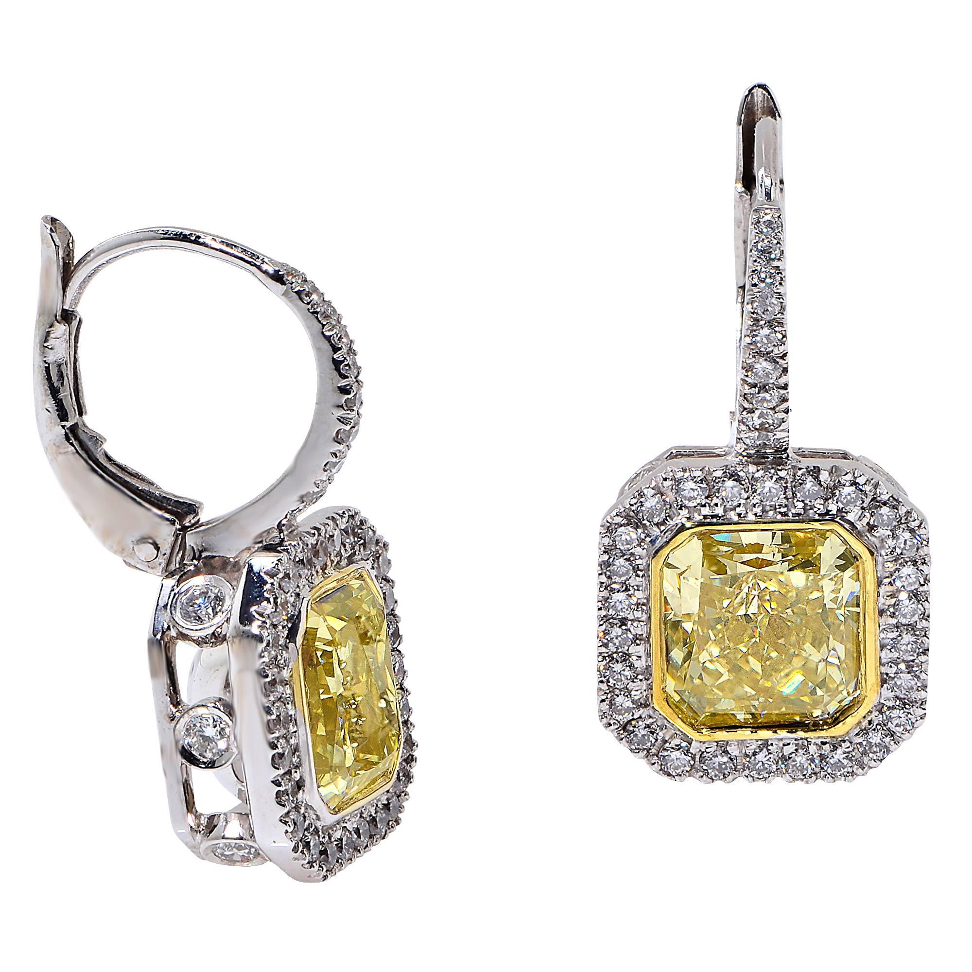 2.02 Carat Fancy Light Yellow, VS2 Clarity, GIA Graded Radiant Cut Diamond Matched with a 1.73 Carat Fancy Yellow, VS2 Clarity, GIA Graded Radiant Cut Diamond Surrounded by 70 Round Brilliant Cut Diamonds Weighing .85 Carats, F Color, VS Clarity,