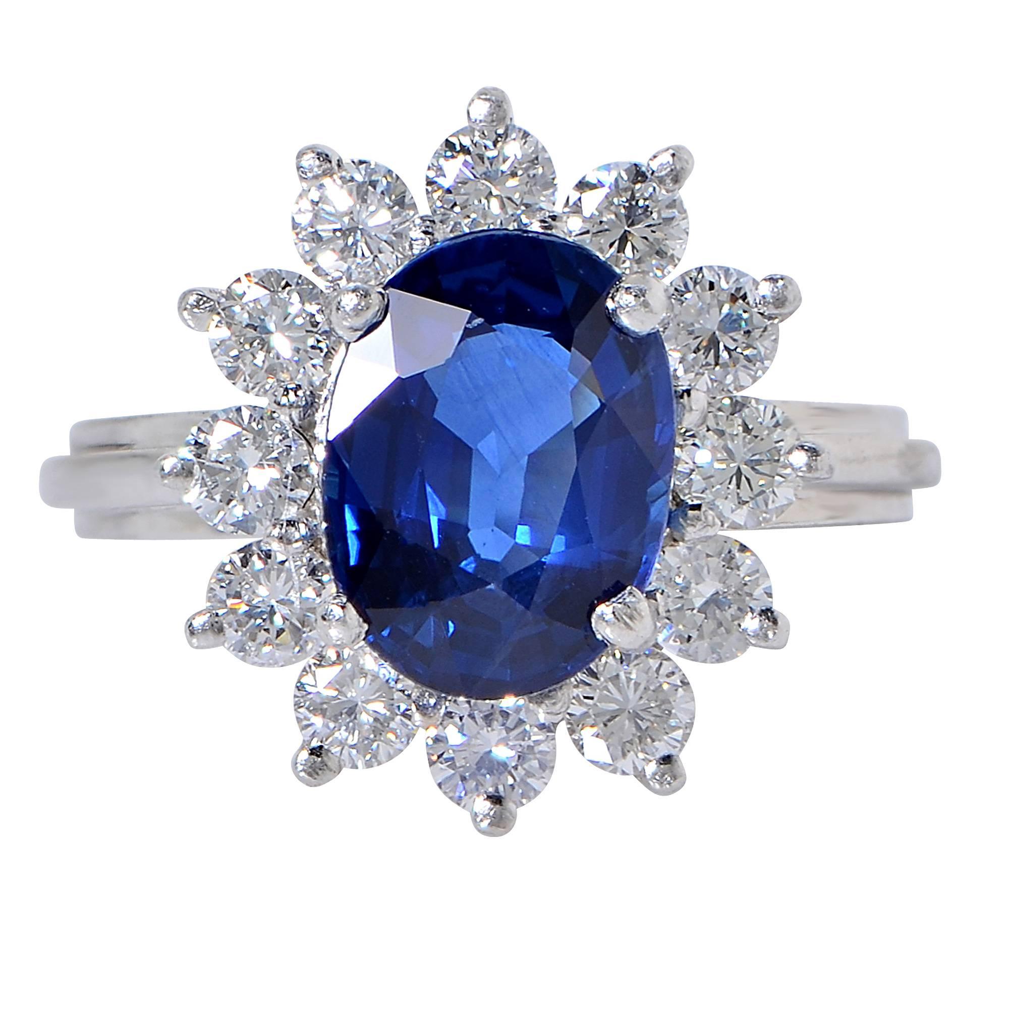 Platinum ring containing a 3.26ct blue sapphire surrounded by 12 round brilliant cut diamonds weighing approximately 1.20cts, F color, VS clarity.

The ring is a size 7 and can be sized up or down.
It is stamped and/or tested as platinum.
The metal