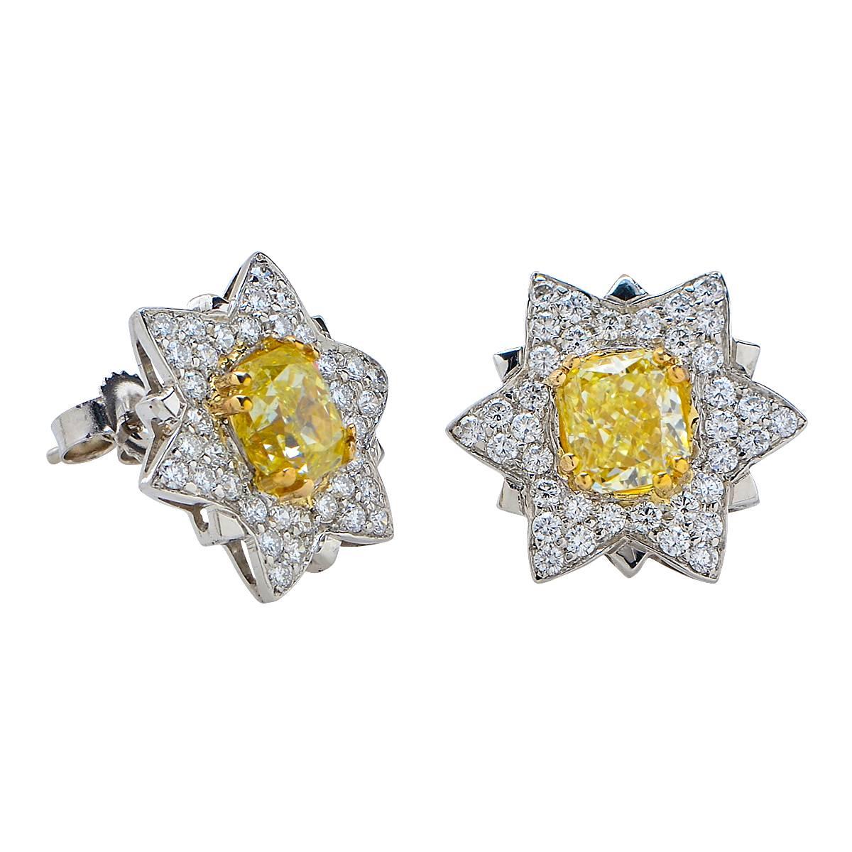 Platinum Earrings Set with 2 Radiant Cut Natural Fancy Yellow Diamonds Weighing Approximately 1.98 Carats Surrounded by .72 Carats of Round Brilliant Cut Diamonds.

Weight: 3.12 grams

These Earrings are Accompanied by a Retail Appraisal