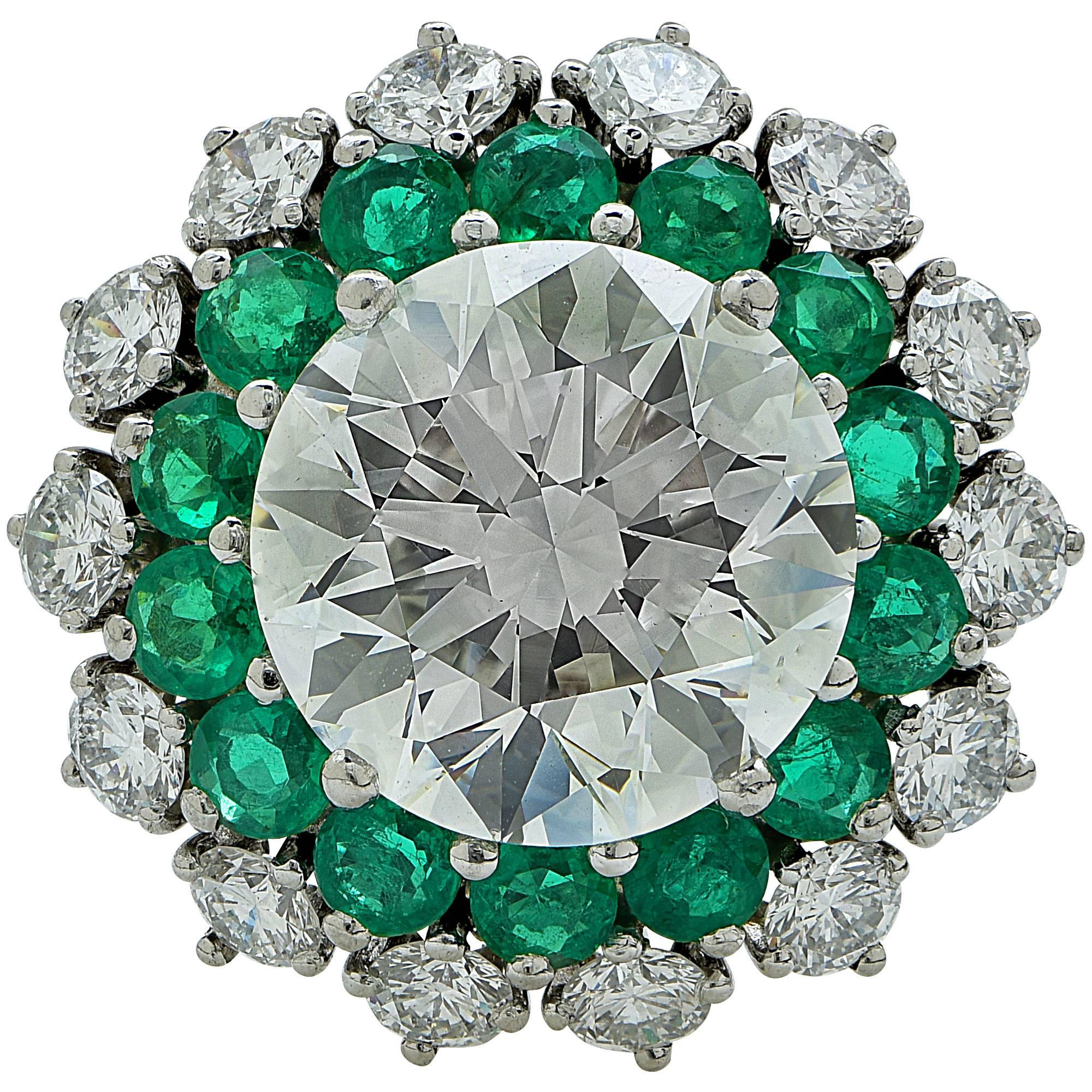 Platinum ring features a GIA graded 5.03ct, K color, SI2 clarity, round brilliant cut diamond and 1.20cts of round cut emeralds.

The ring is a size 6 and can be sized up or down.
It is stamped and tested as platinum.
The metal weight is 6.23