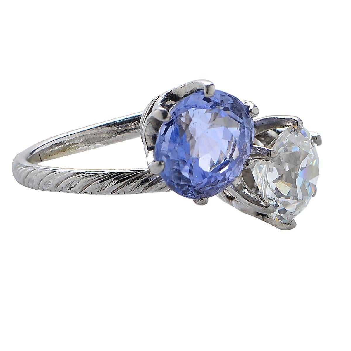 Tiffany & Co. platinum diamond and sapphire bypass ring featuring a GIA graded 1.78ct old European cut diamond, I color, VS2 clarity, and a round cut sapphire with an estimated weight of 2.10cts.

Ring Size: 5.5
Weight: 7.46 grams

This diamond