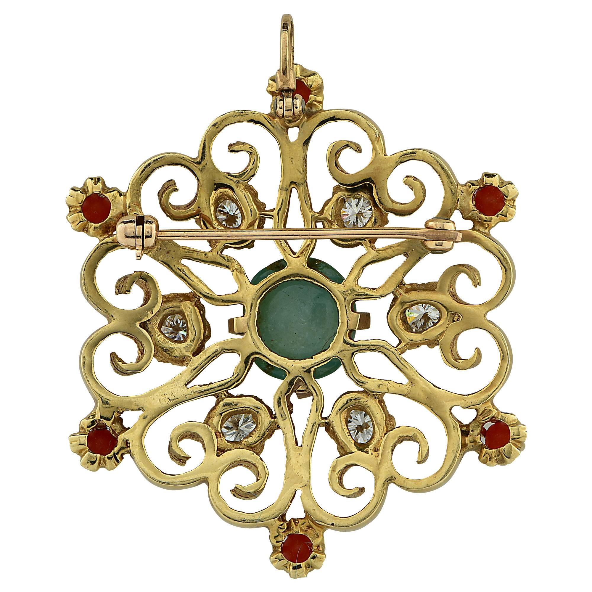 Emerald and diamond brooch featuring a cabochon cut emerald center weighing approximately 1.20cts surrounded by 6 round brilliant cut diamonds with an estimated total weight of .90cts and 6 cabochon cut coral with an estimated total weight of