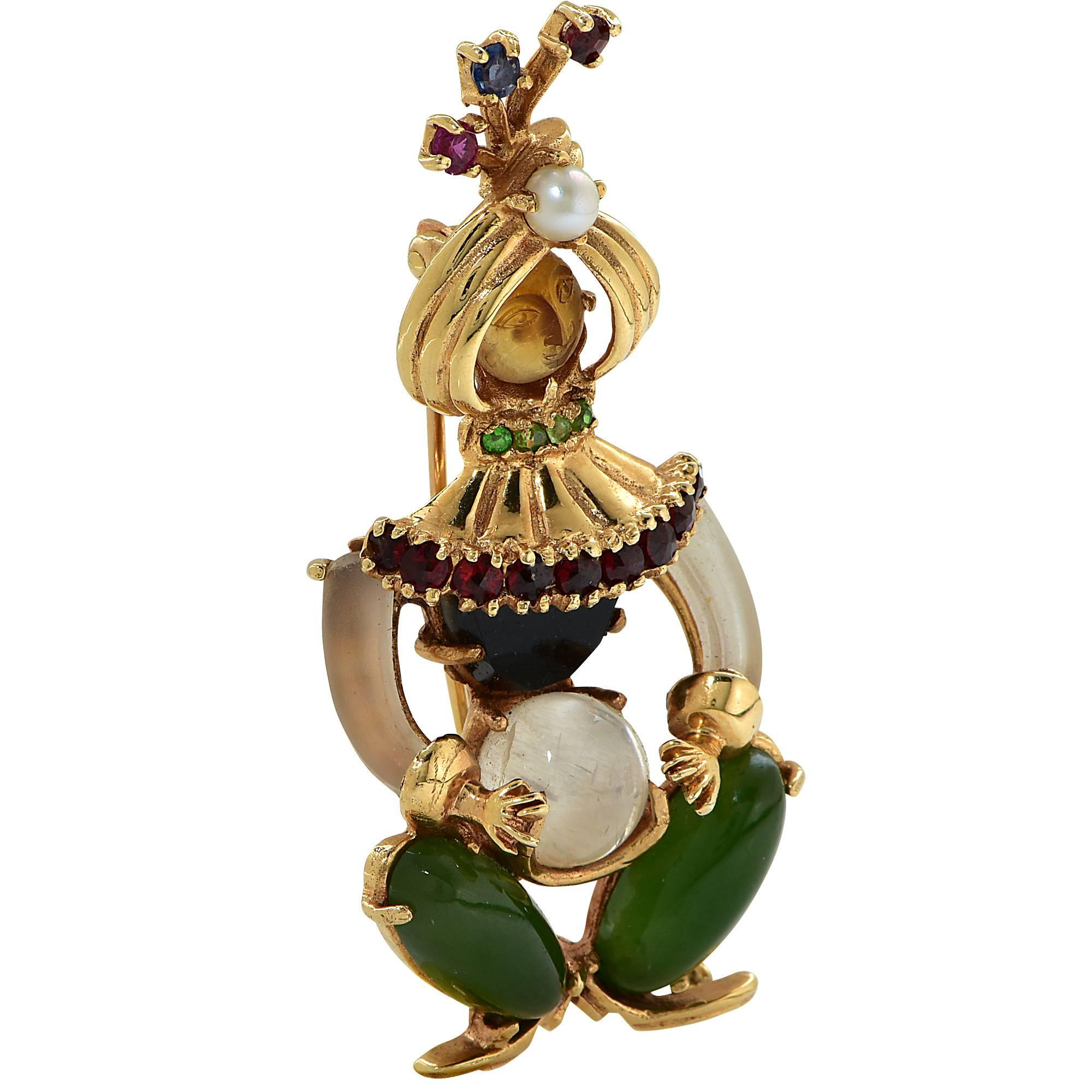 14k yellow gold vintage harlequin brooch featuring rock crystal, garnets and jade.

Measurements: 2 inch length by .8 width inch by .40 inch depth
Metal weight: 13.99 grams

This gemstone brooch is accompanied by a retail appraisal performed by