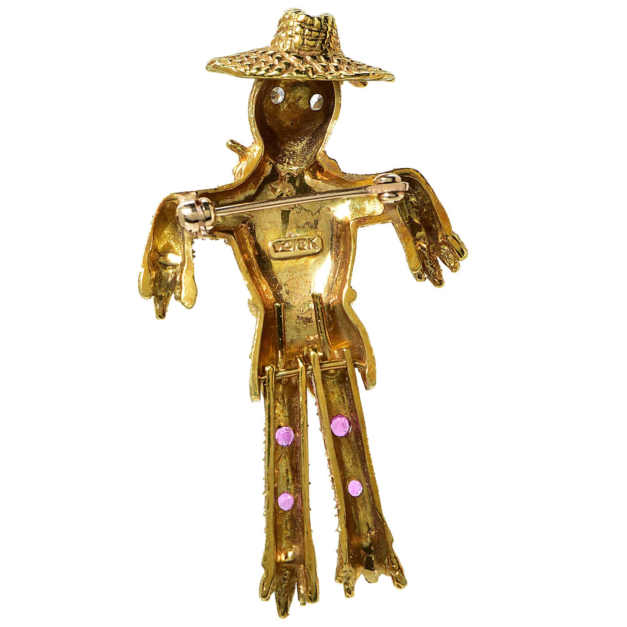 18k yellow gold scarecrow brooch featuring 2 single cut diamonds weighing .02cts total, G color, VS clarity.

Measurement: 2 inch length by 1.2 inch width by .3 inch depth
Metal weight: 12.36 grams

This brooch is accompanied by a retail