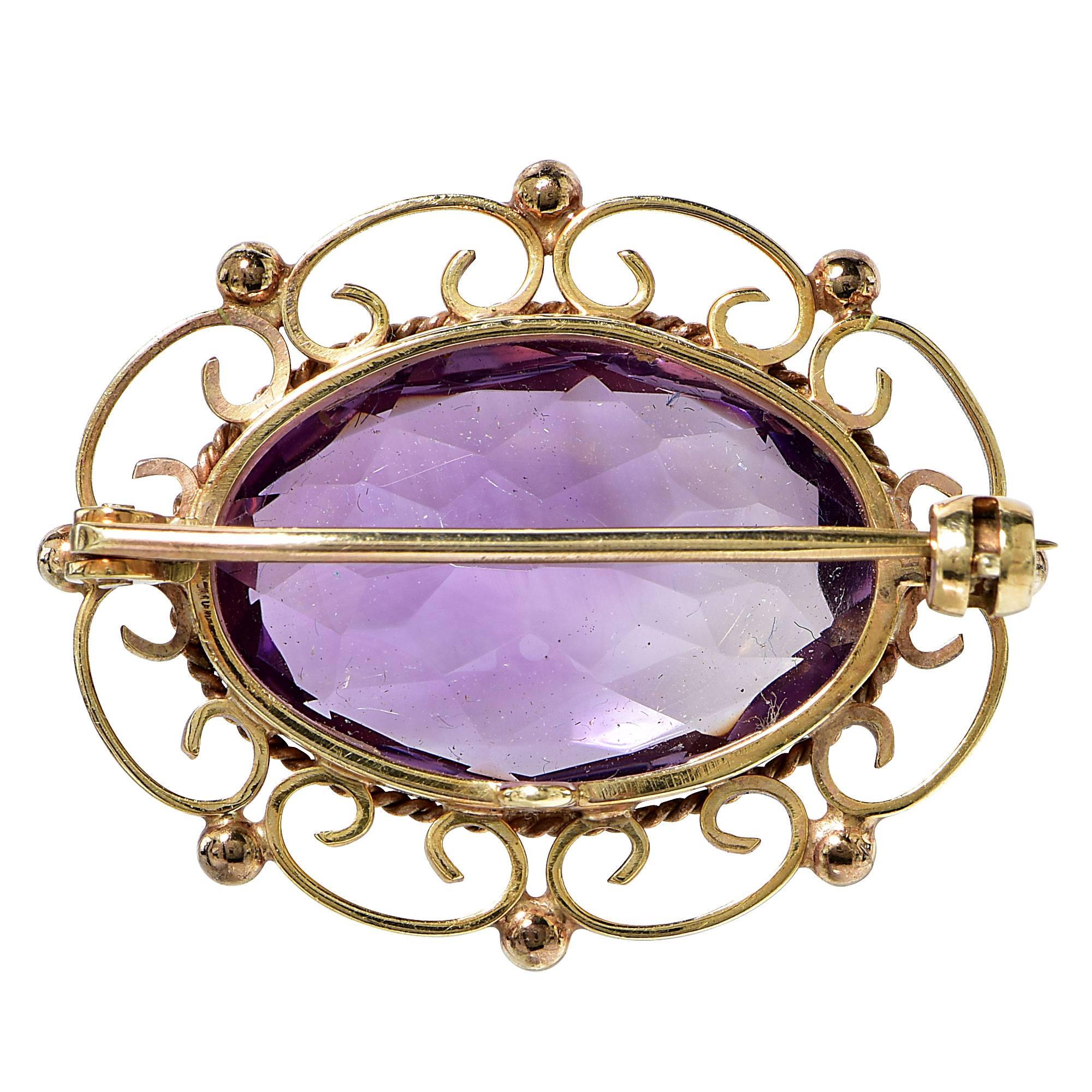 9k vintage brooch featuring an oval cut amethyst weighing approximately 20cts.

Metal weight: 8.39 grams

This brooch is accompanied by a retail appraisal performed by a Graduate Gemologist.