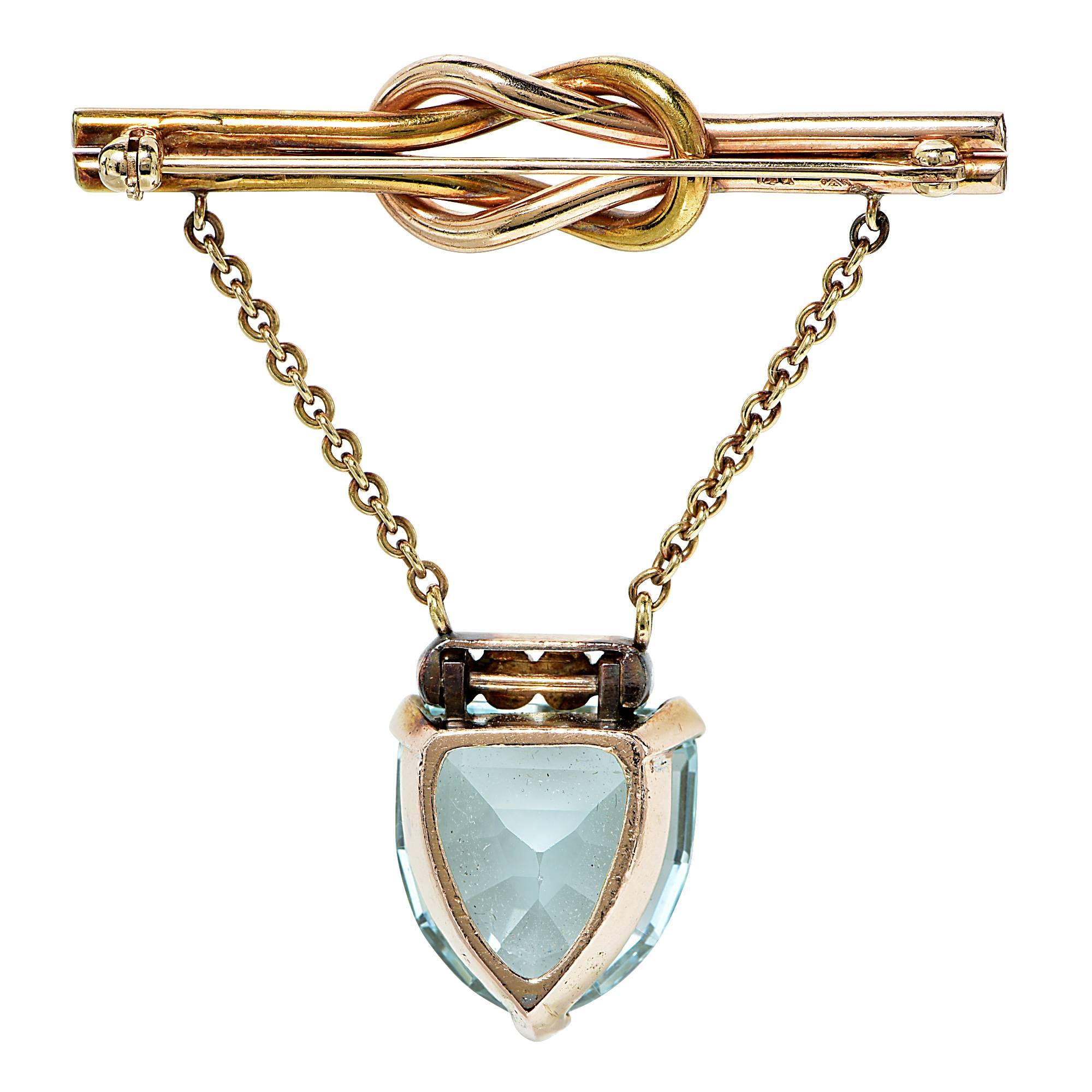 14k yellow and rose gold vintage brooch featuring a shield cut aquamarine weighing approximately 20cts accented by 4 round brilliant cut diamonds weighing approximately .30cts total, G color VS clarity.

Metal weight: 16.32 grams

This
