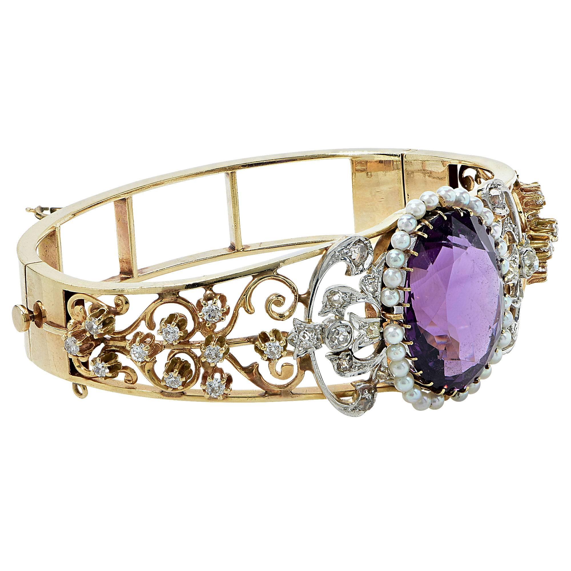 Yellow gold bangle from the Victorian era containing a 21ct amethyst surrounded by pearls, assumed to be natural and accented by 40 mixed cut diamonds weighing approximately 1.20cts.

Metal weight: 33.97 grams

This bracelet is accompanied by a